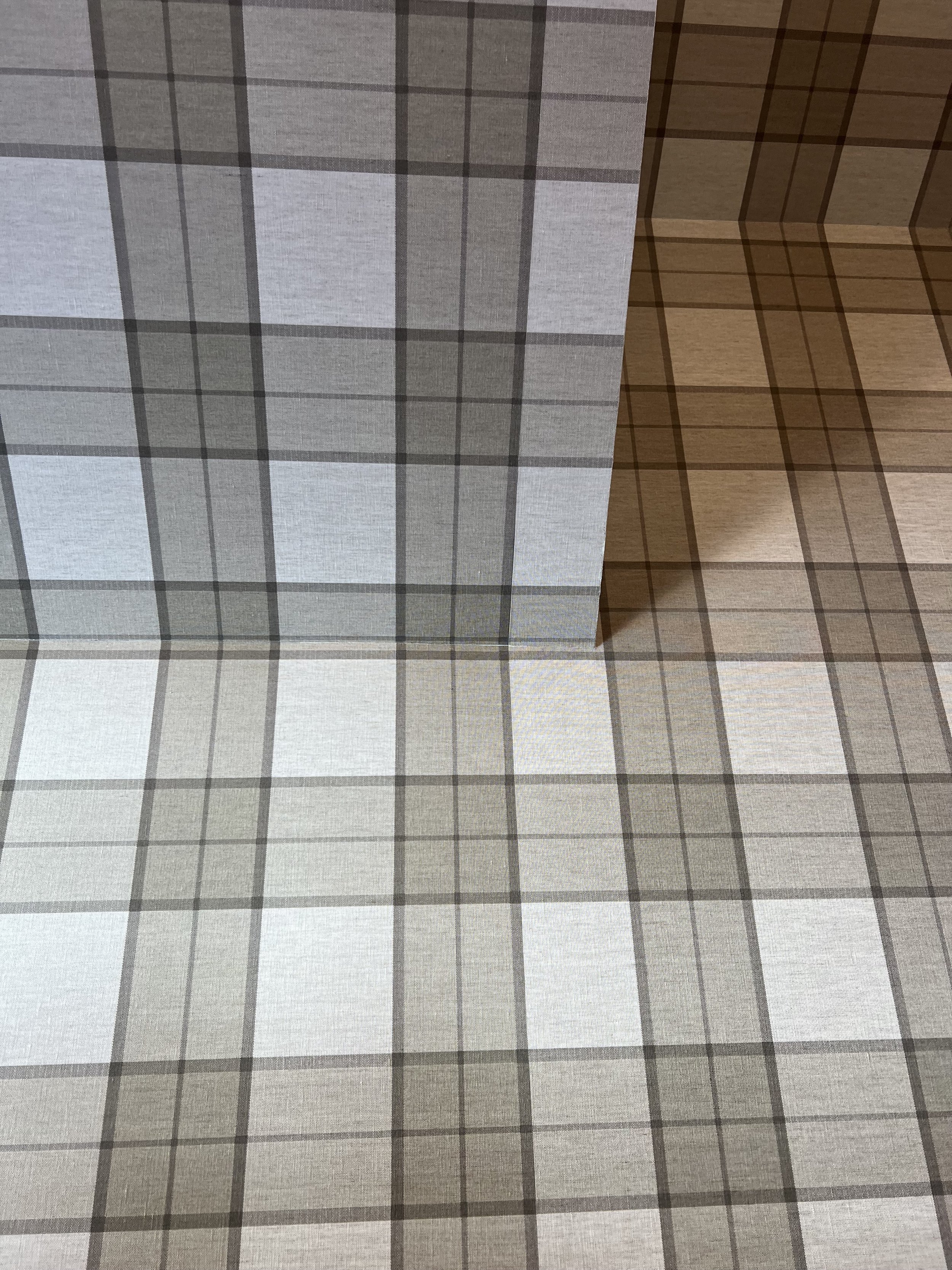 Checkered pattern wallpaper on a corner wall