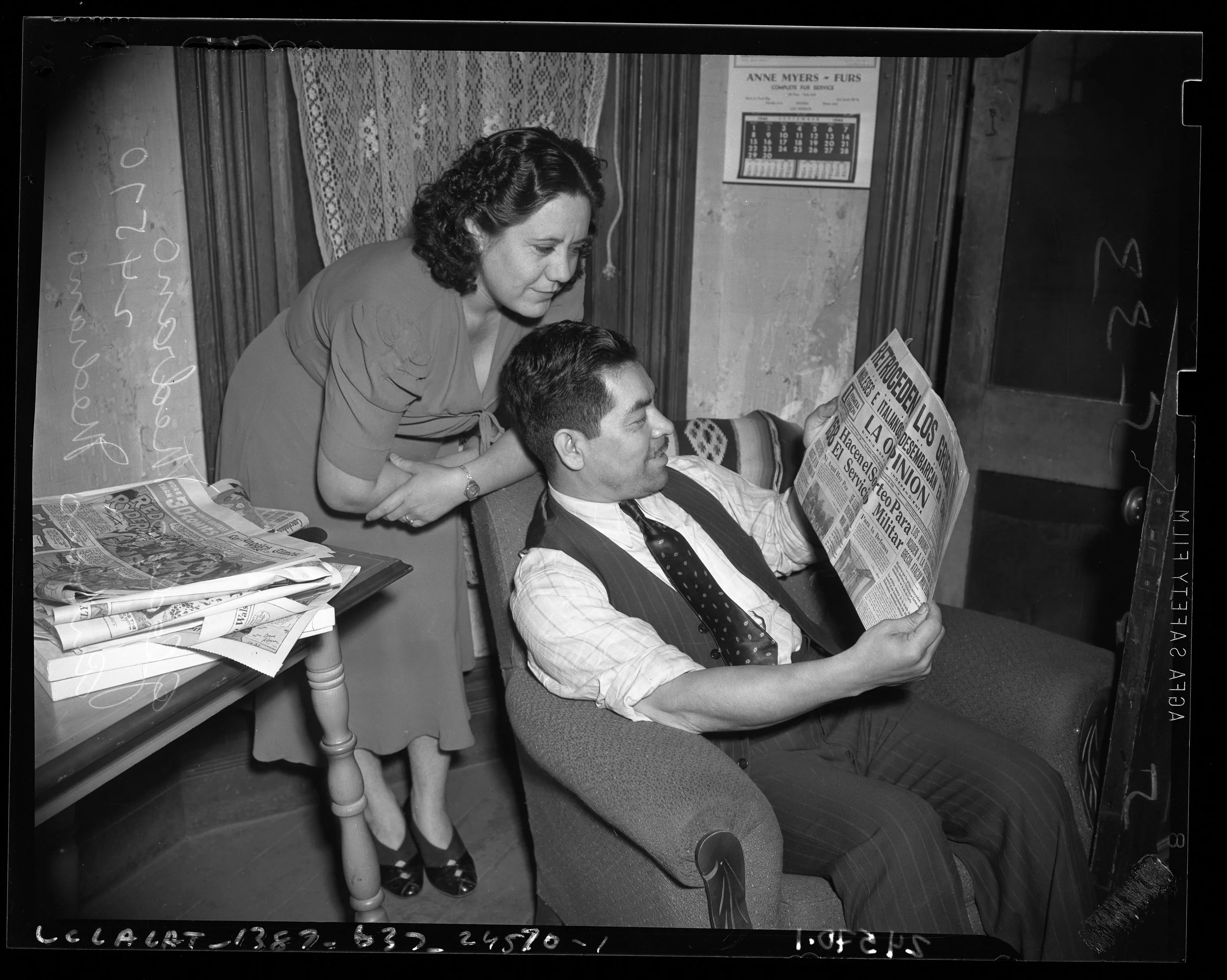 Photo of two people reading the Spanish-language newspaper La Opinion, which Robert and Lorraine's grandfather read. Citation: Antonio and Gladys Medrano reading Spanish language newspaper "La Opinion" in Los Angeles, Calif., 1940, B&W Negative, Los 