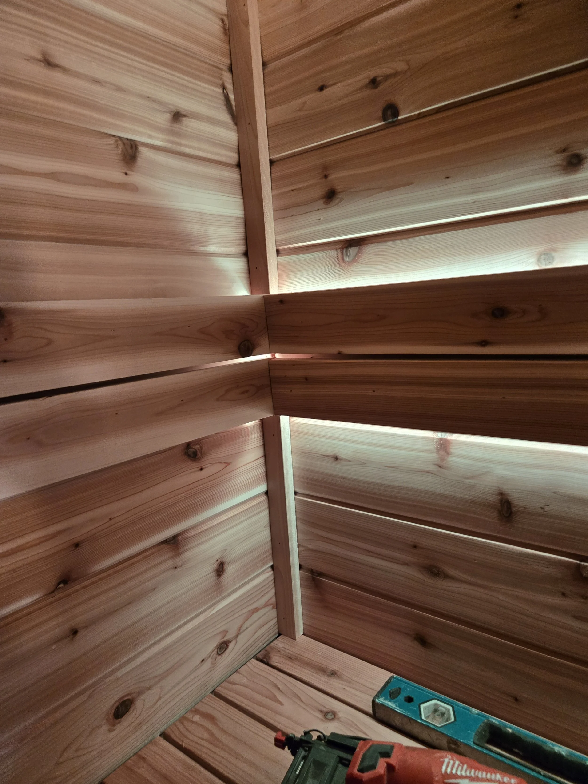 interior view of wooden paneled wall with construction tools