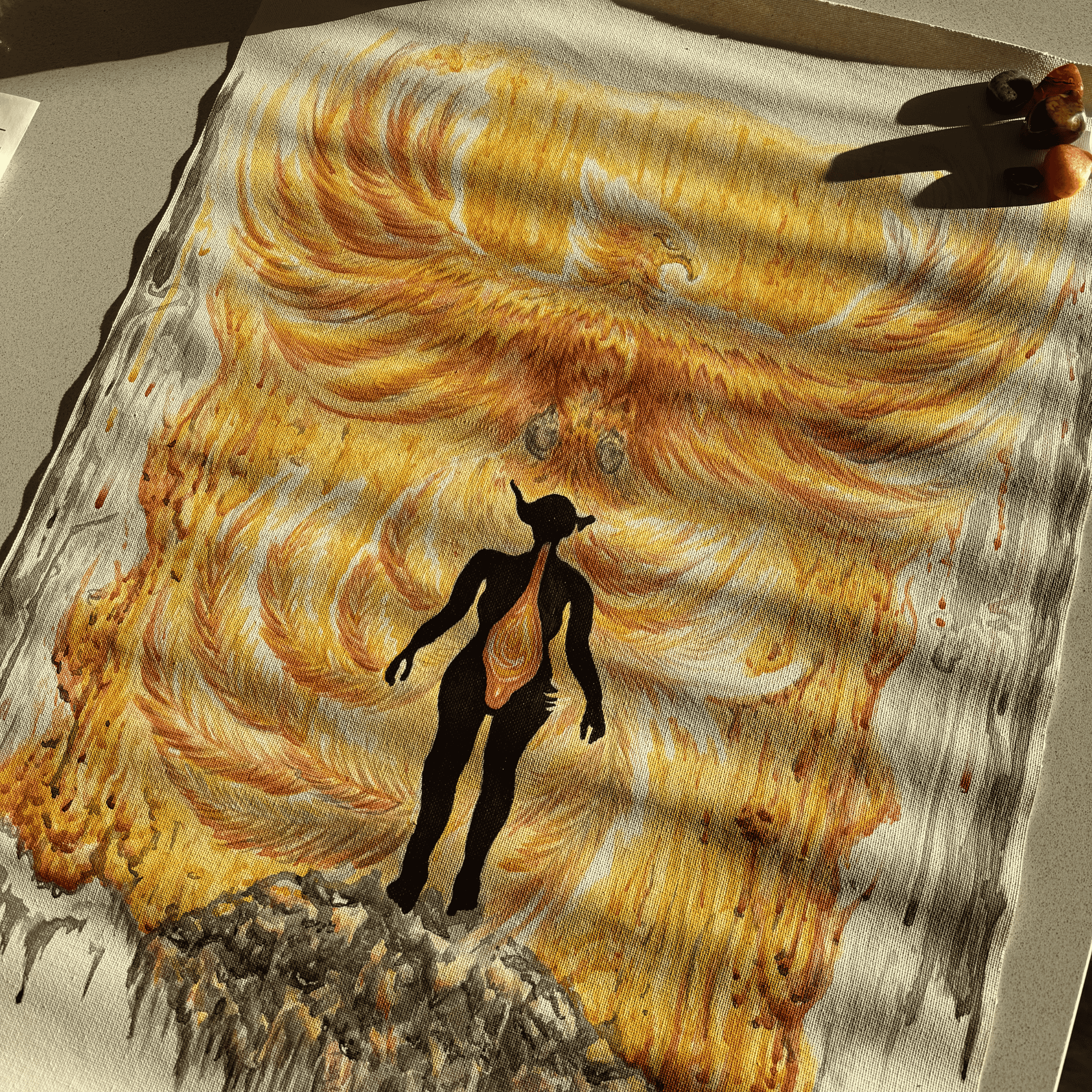 A Phoenix made of flames and a silhoute of a half human half elf standing on a pile of floating embers and ash
