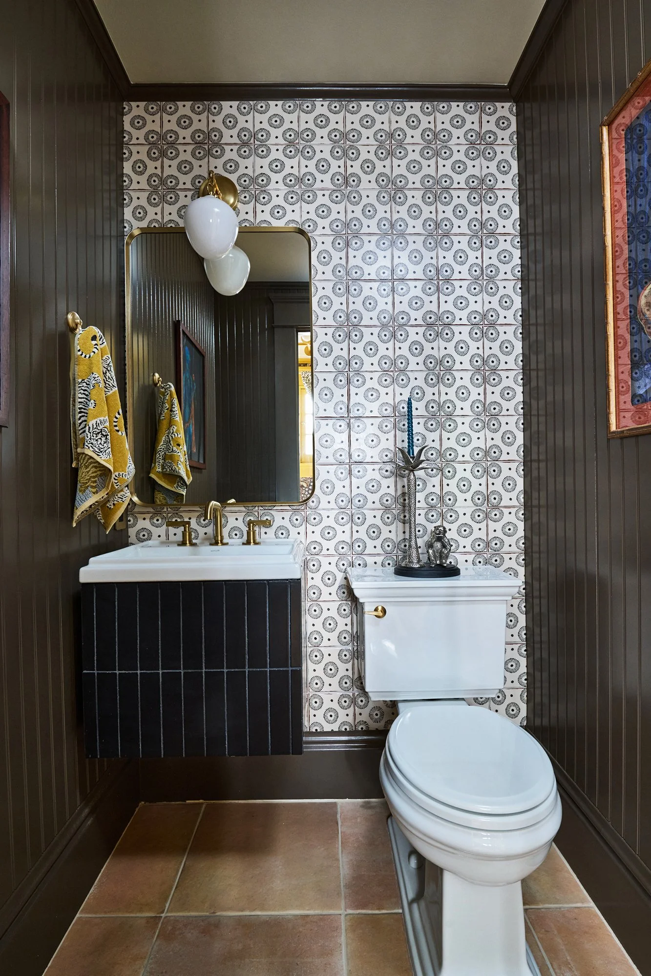 Powder Room, Pattern Tile back wall, Black tile vanity, brown bead board, Monkey and palm tree candle holder