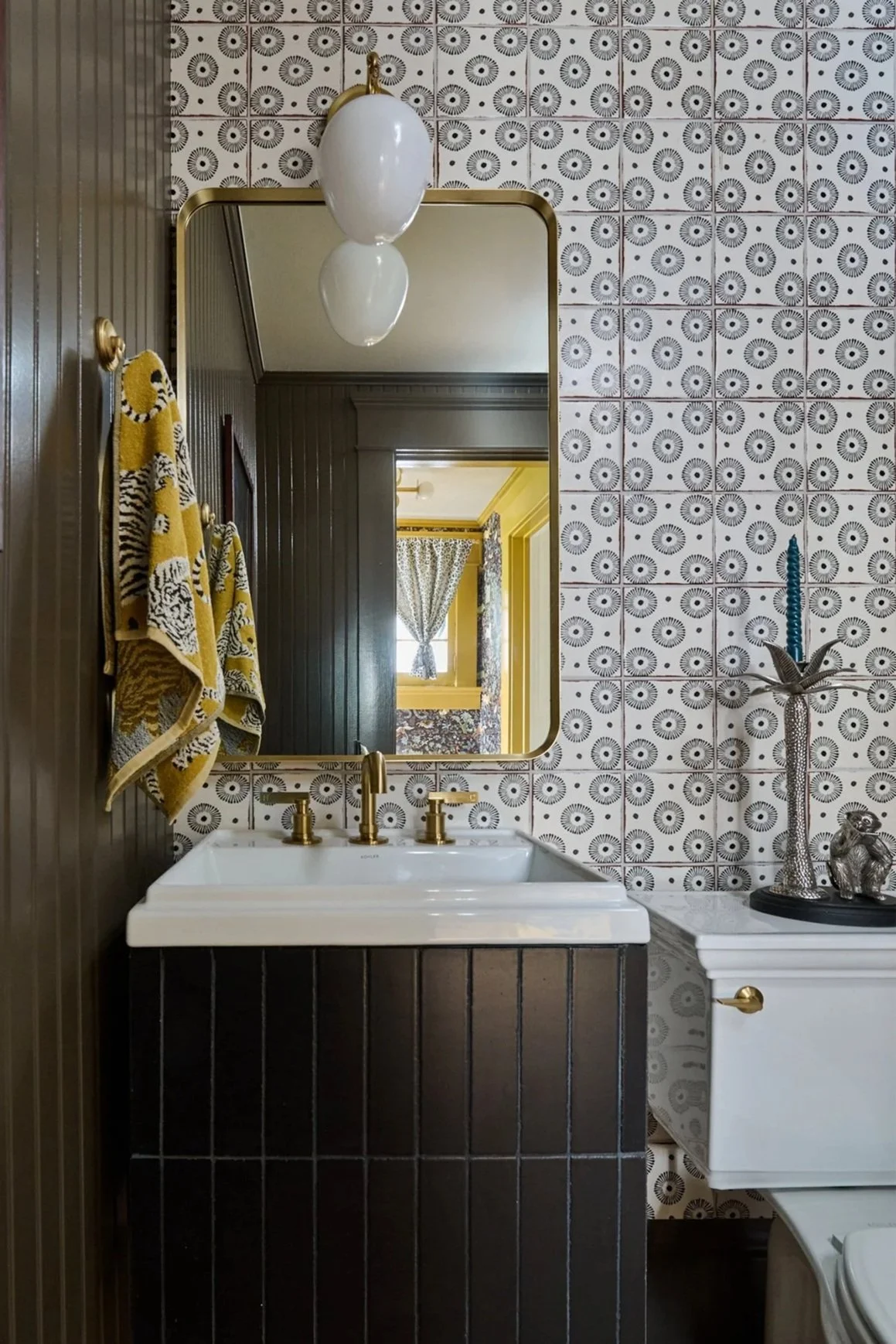 Powder Bathroom, black tile, pattern tile wall, Kohler sink, mirror, brass mirror, tiger towel