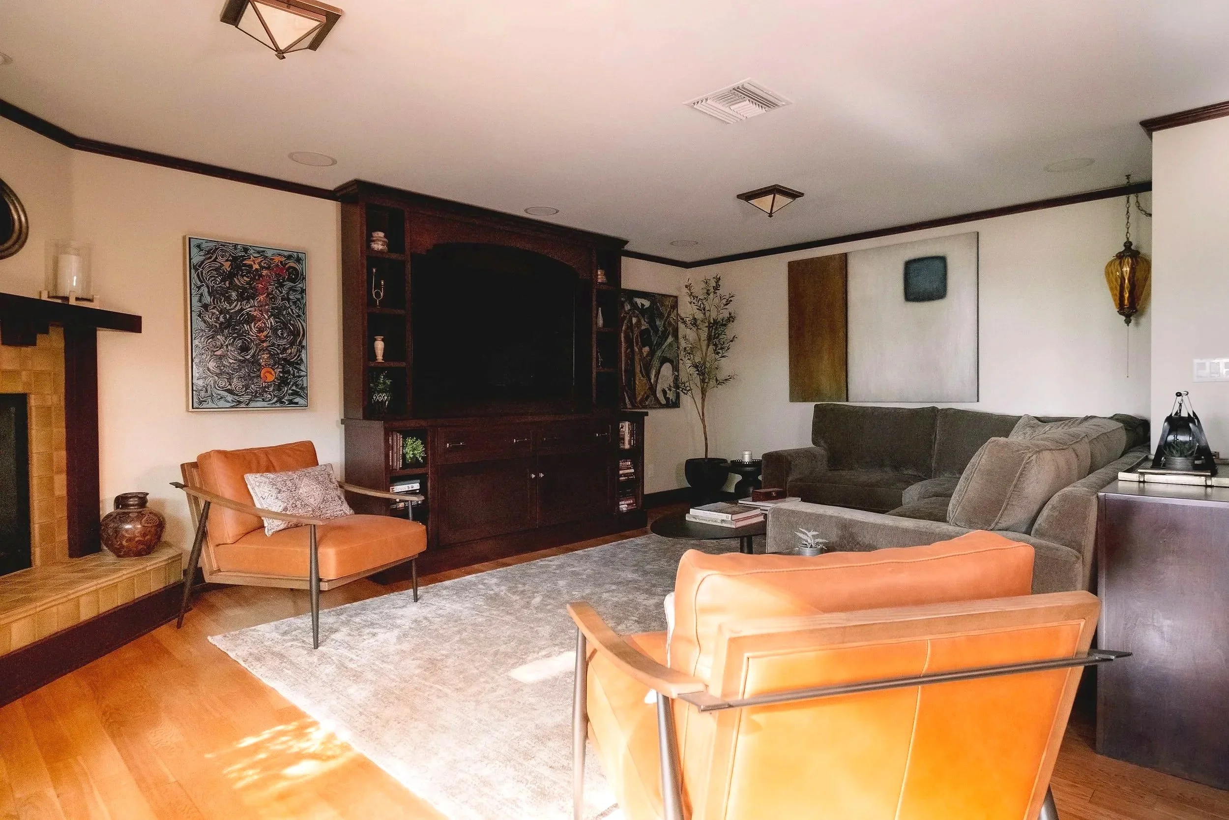 Living room. Altadena. Leather chairs, green couch, wood TV cabinet