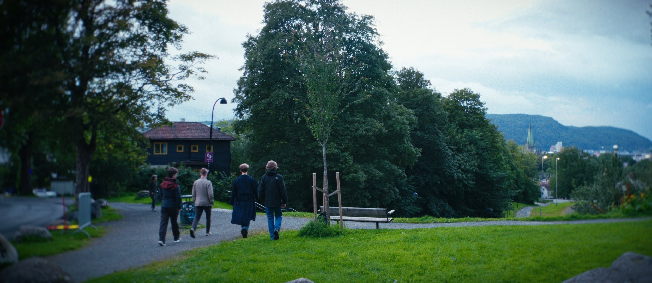 People walking through a green park in Trondheim, from NorthHugr documentary footage.