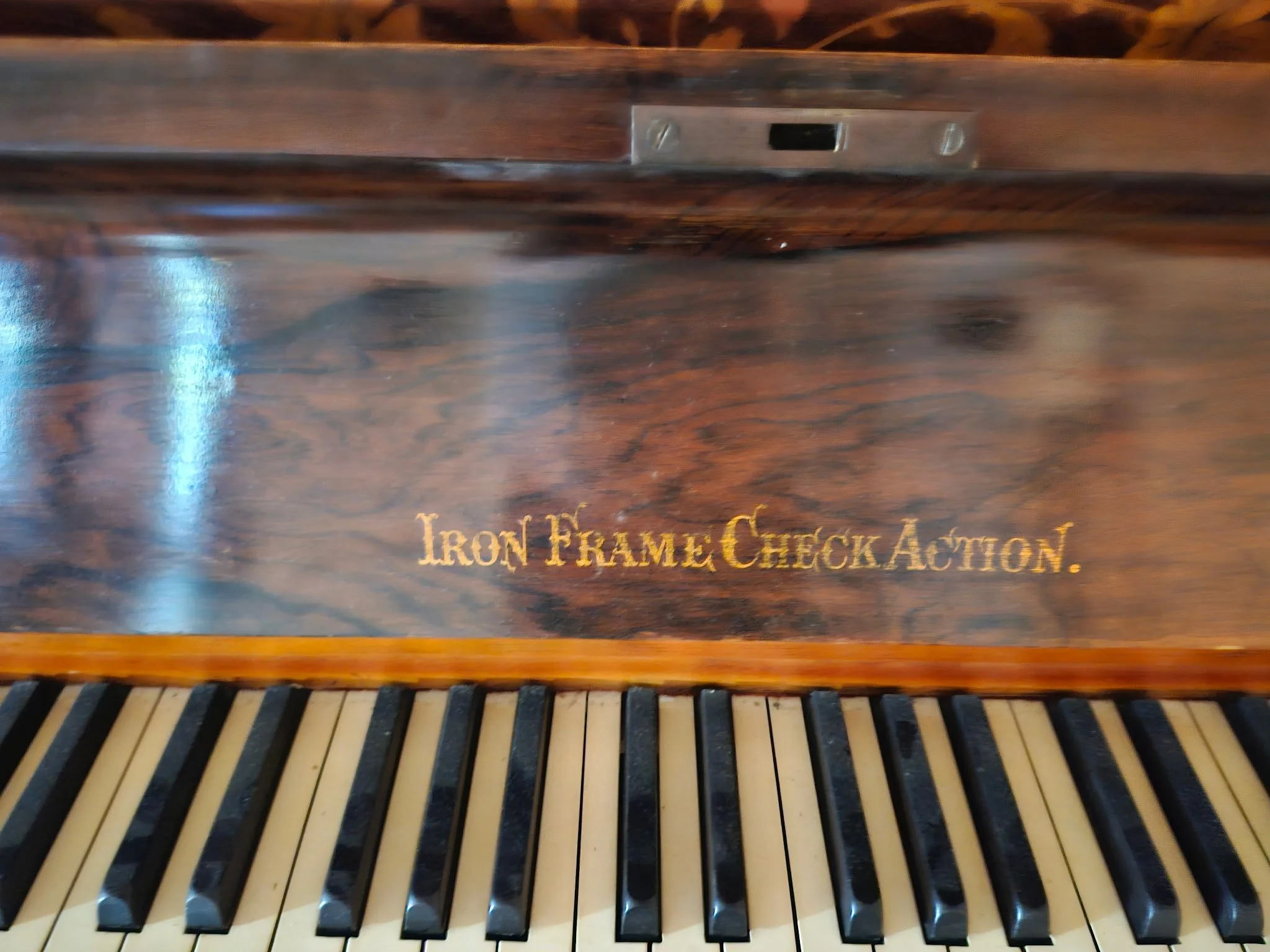 This is the fall board from the Deacock piano which would typically show who built it but instead says "Iron Frame Check Action.