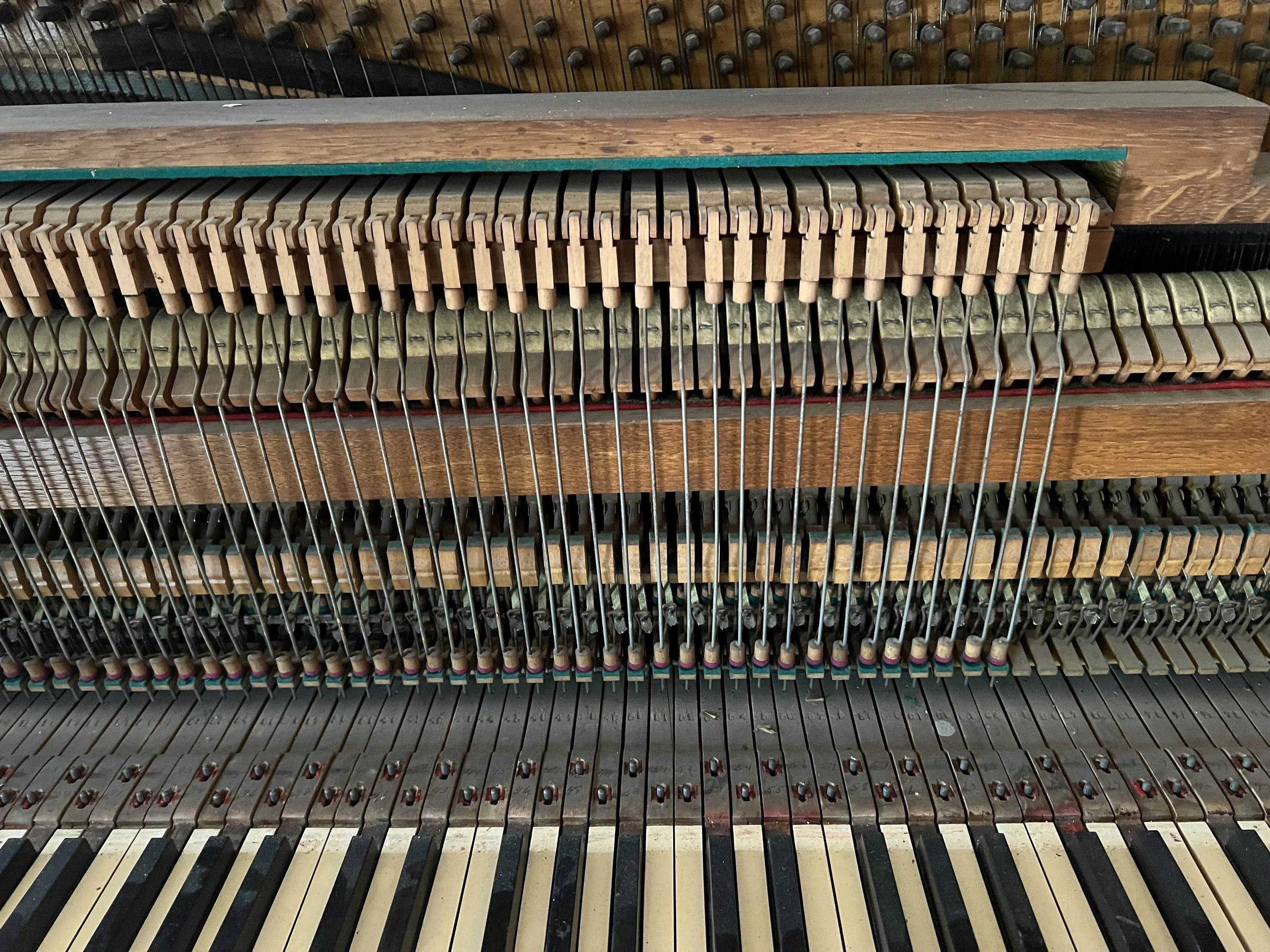 Here's the action of the John J. Deacock piano. What is interesting here is that this is an example of a "birdcage" action. You can see the metal stickers that control the dampers which are above the hammers rather than below them as is the case wi