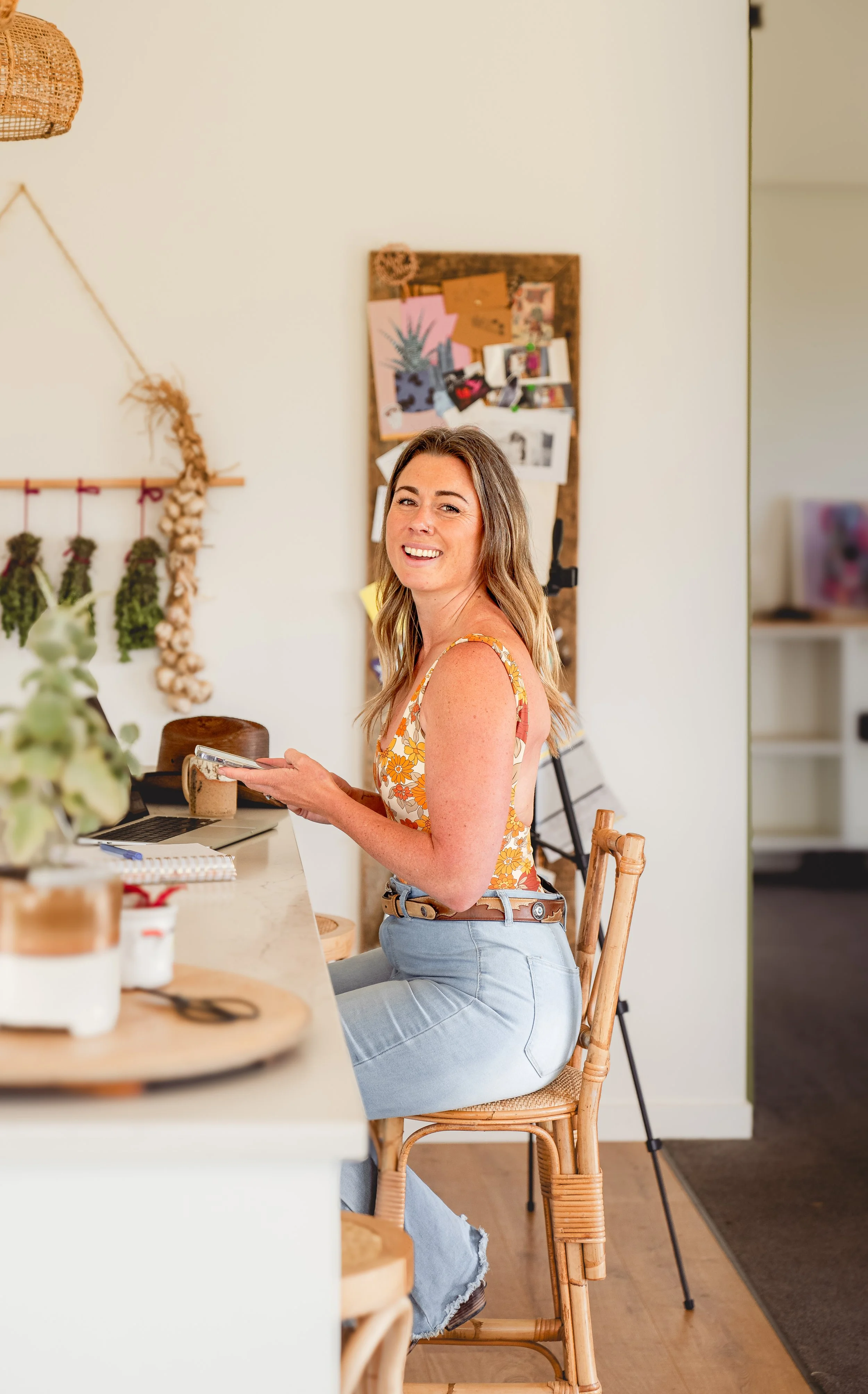 Creative-Marketing-Consultant-krista-grant-on-phone-kitchen-bench