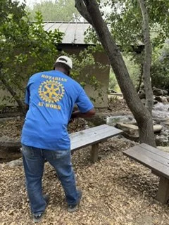 Rotarian, Roy Jefferson, refurbishing a local park bench during a day of service at Oak Canyon Nature Center. 