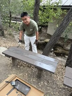 Interact Member (Youth Rotarian) refurbishing a local park bench during a day of service at Oak Canyon Nature Center. 