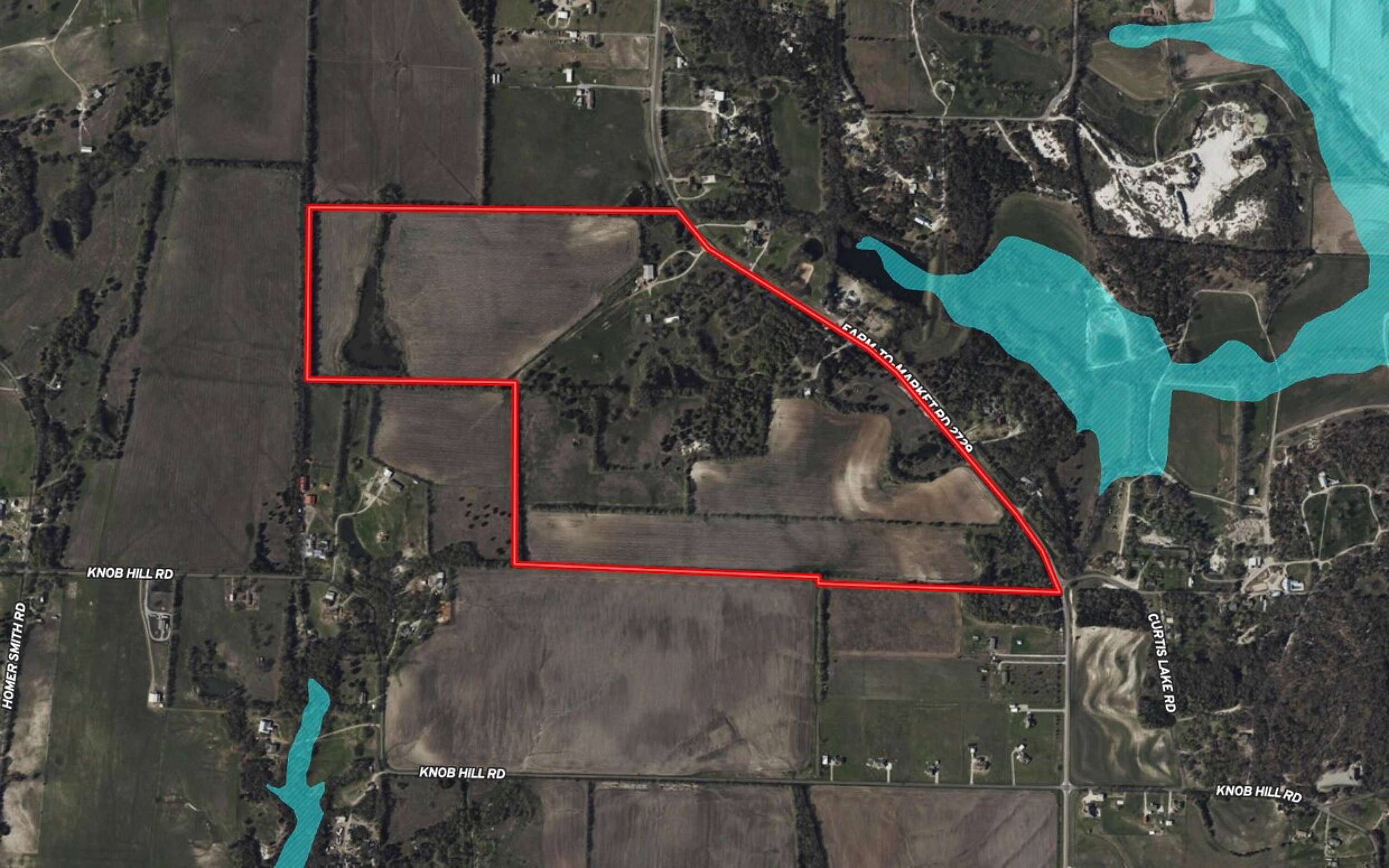 Aerial view of rural land with a red boundary outline, surrounding fields, lakes, and roads, including Knob Hill Road and Curtis Lake Road.