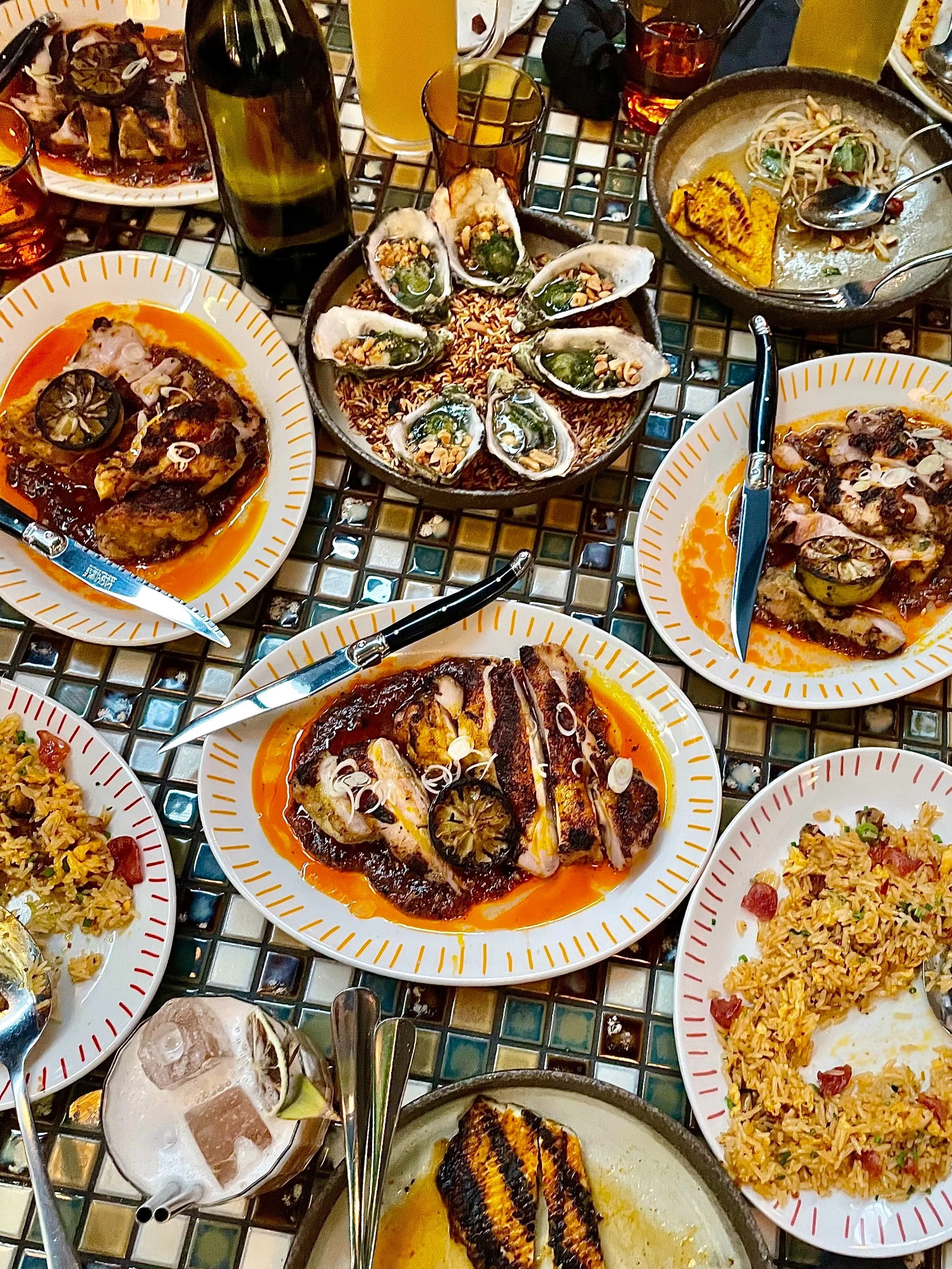 Table with various food dishes such as roasted chicken & oysters
