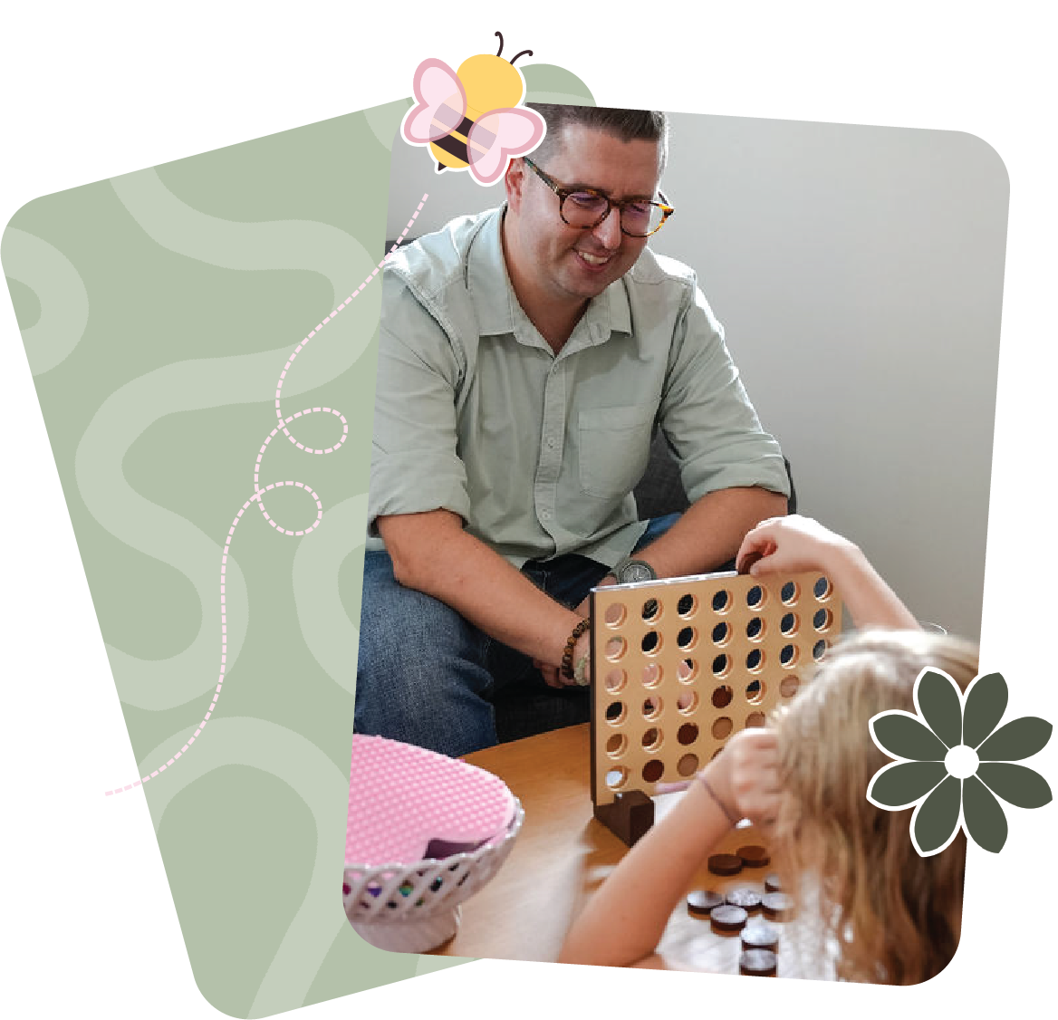A clinician and a young girl playing Connect Four at a table.