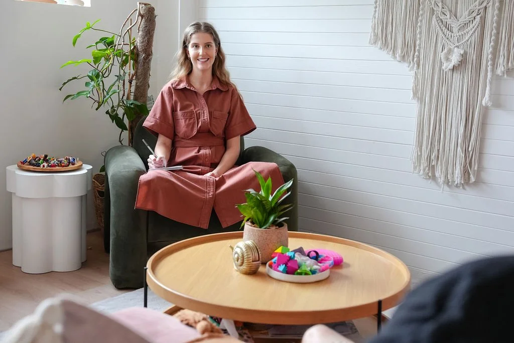 Flourish clinician, Brooke Griffin, talking with a couple about neuroaffirming therapy for their child.