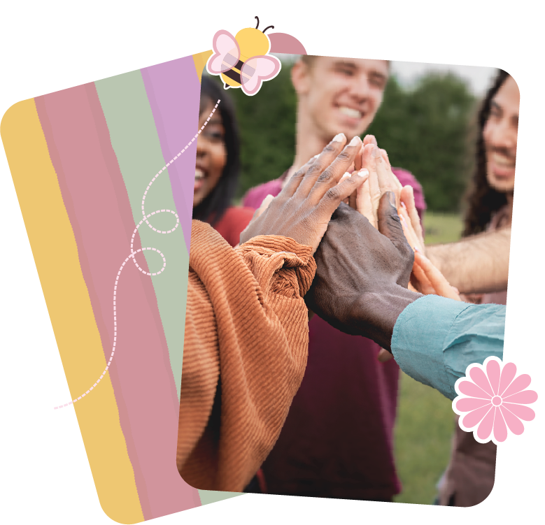 People of diverse backgrounds giving high-fives outdoors with trees in the background.