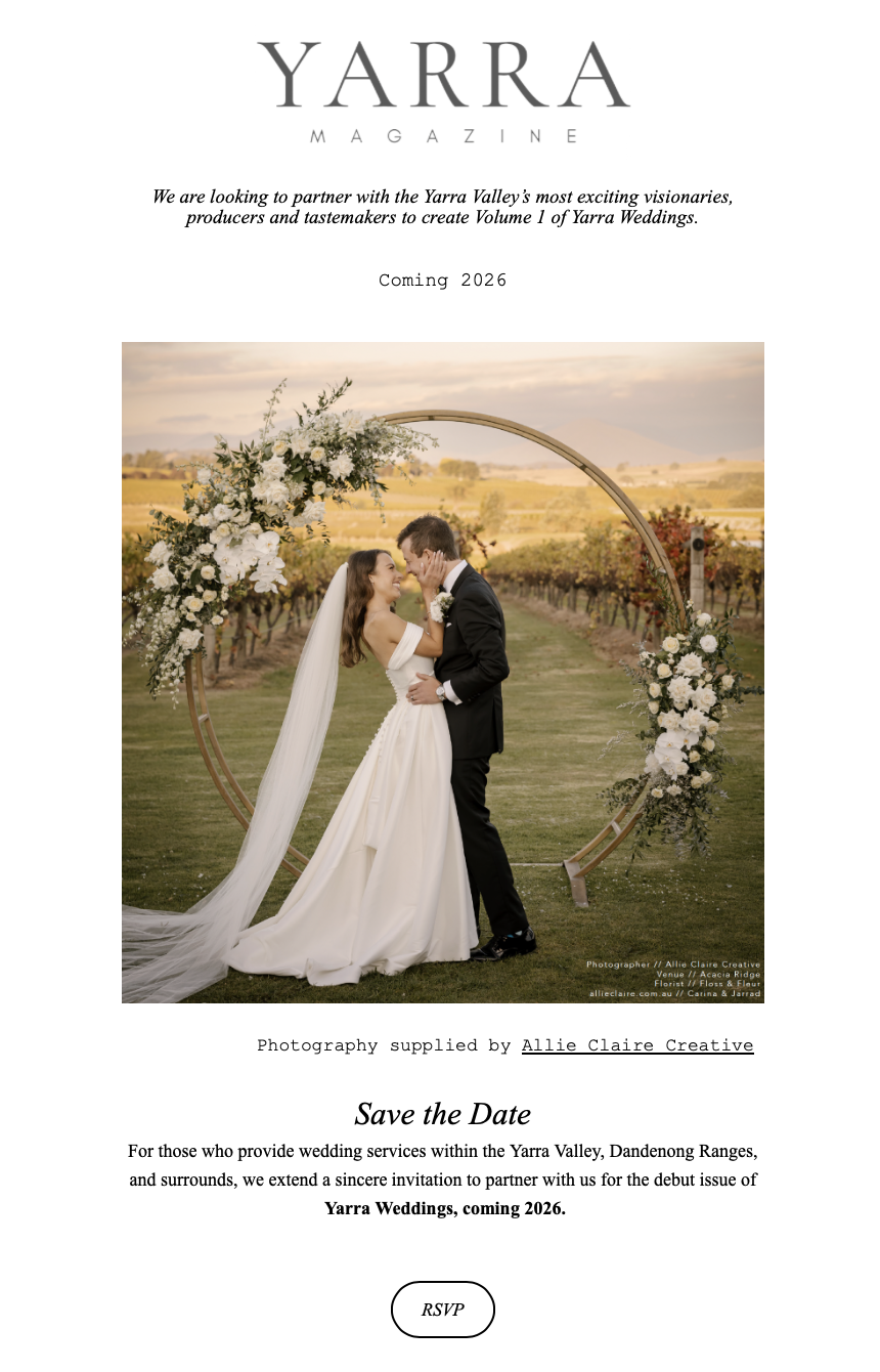 A wedding magazine cover featuring a couple kissing outdoors with a circular floral arch and vineyard background at sunset.