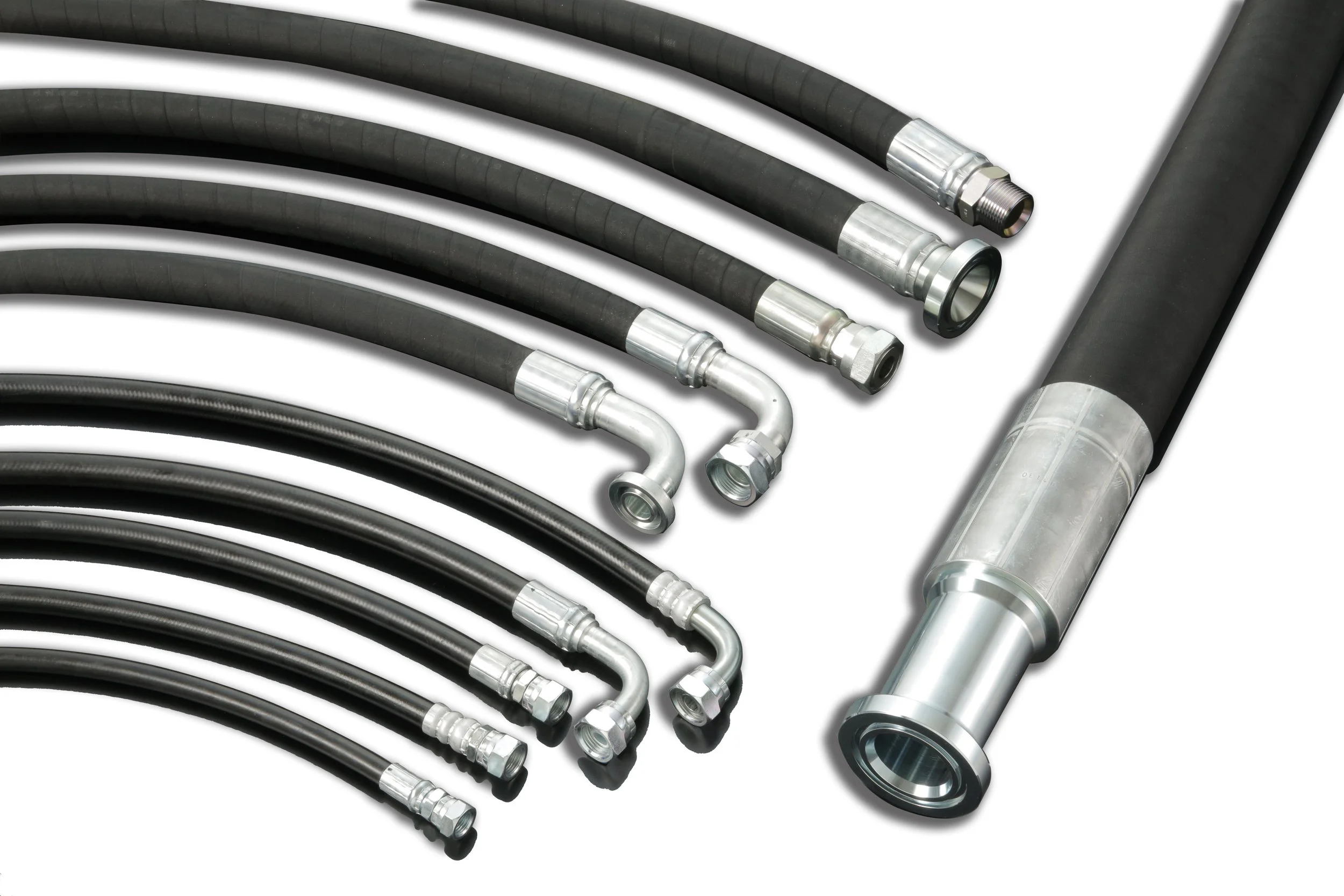 Various black hydraulic hoses with metal fittings and connectors arranged on a white surface.