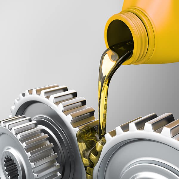 Motor oil being poured into gears of a mechanical system.