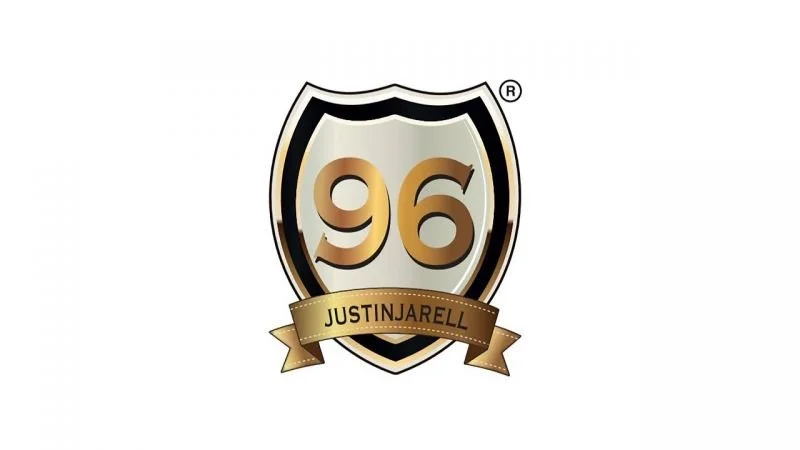 A shield-shaped logo with a black, gold, and silver color scheme displaying the number 96 and the name JustinJarell on a gold banner.