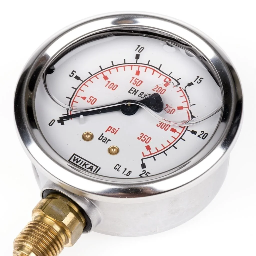 A pressure gauge showing zero pressure with a brass connector at the bottom.
