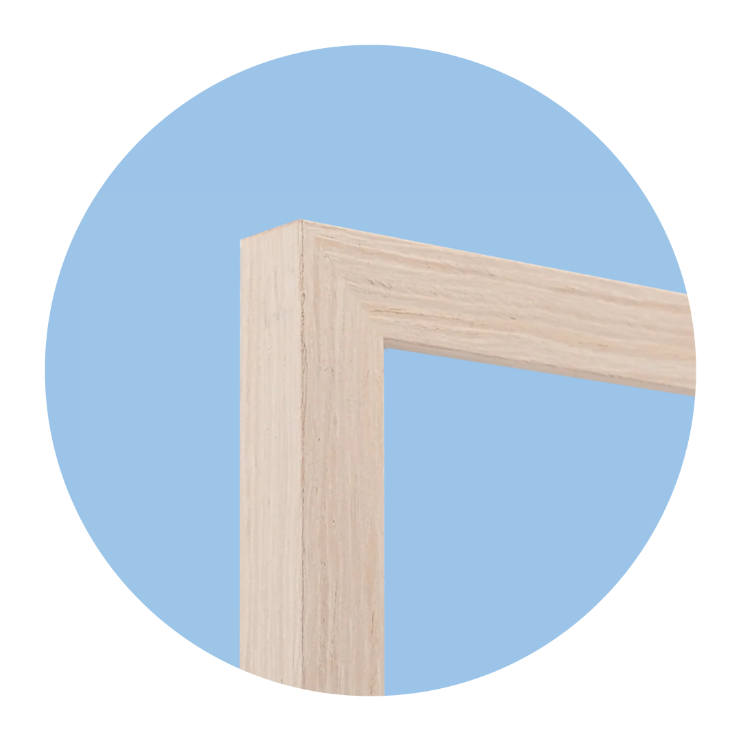 Close-up of a wooden picture frame with a light beige color, against a blue background.