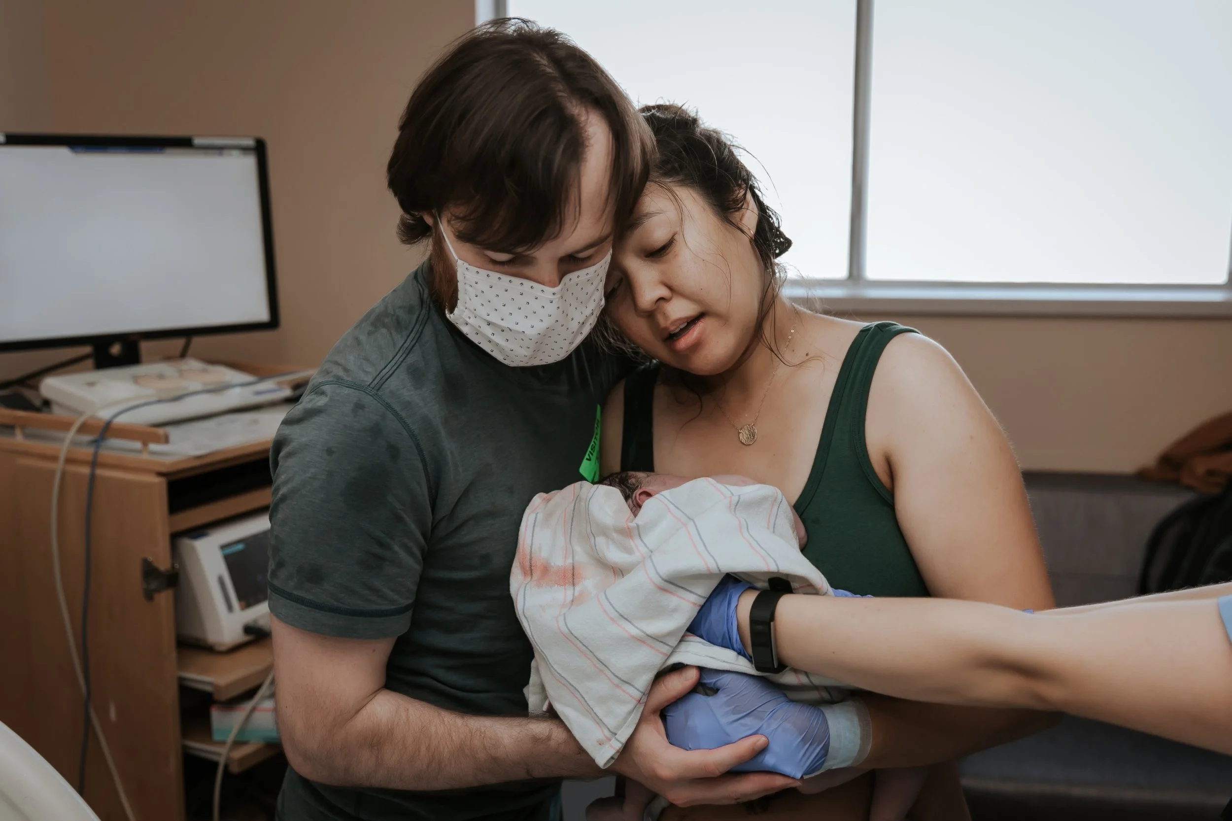Mom greeting baby after birth. Photo taken by Bay Area Birth Photographer Paige Driscoll.