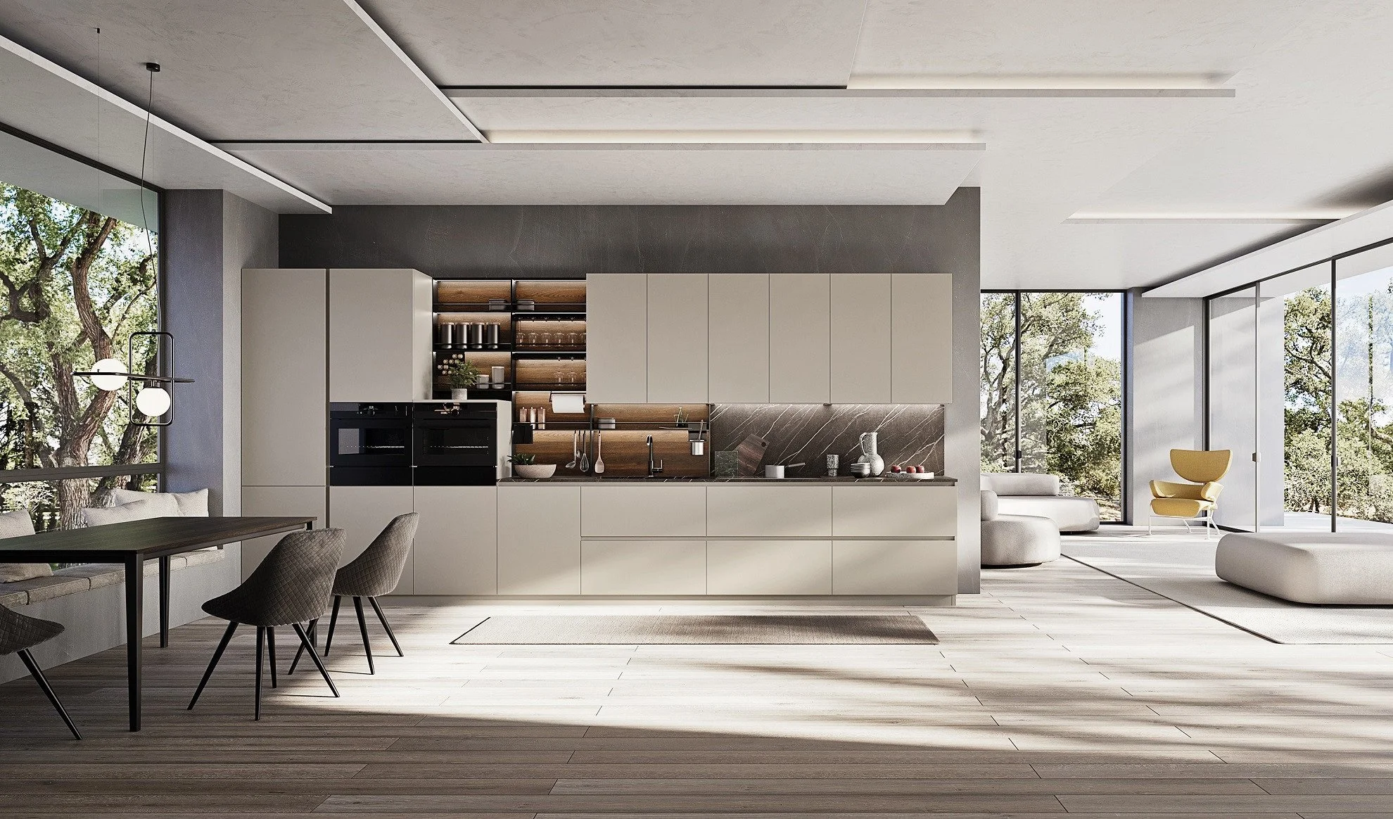 Modern open-concept living space with a kitchen, dining area, and lounge, featuring large windows with views of trees, sleek cabinetry, and minimalist furniture.
