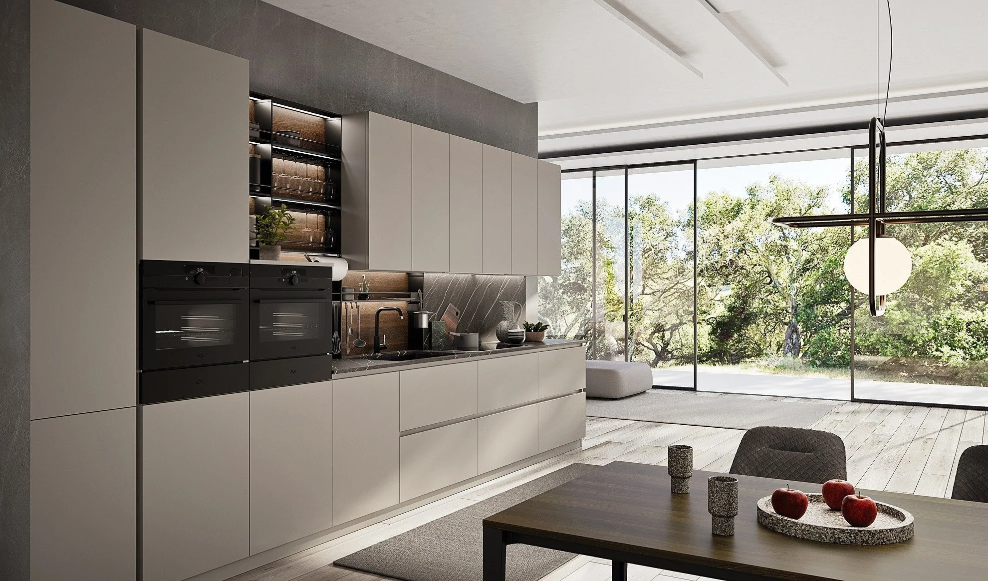 Modern kitchen with white cabinets, black appliances, and a large glass wall showing trees outside.