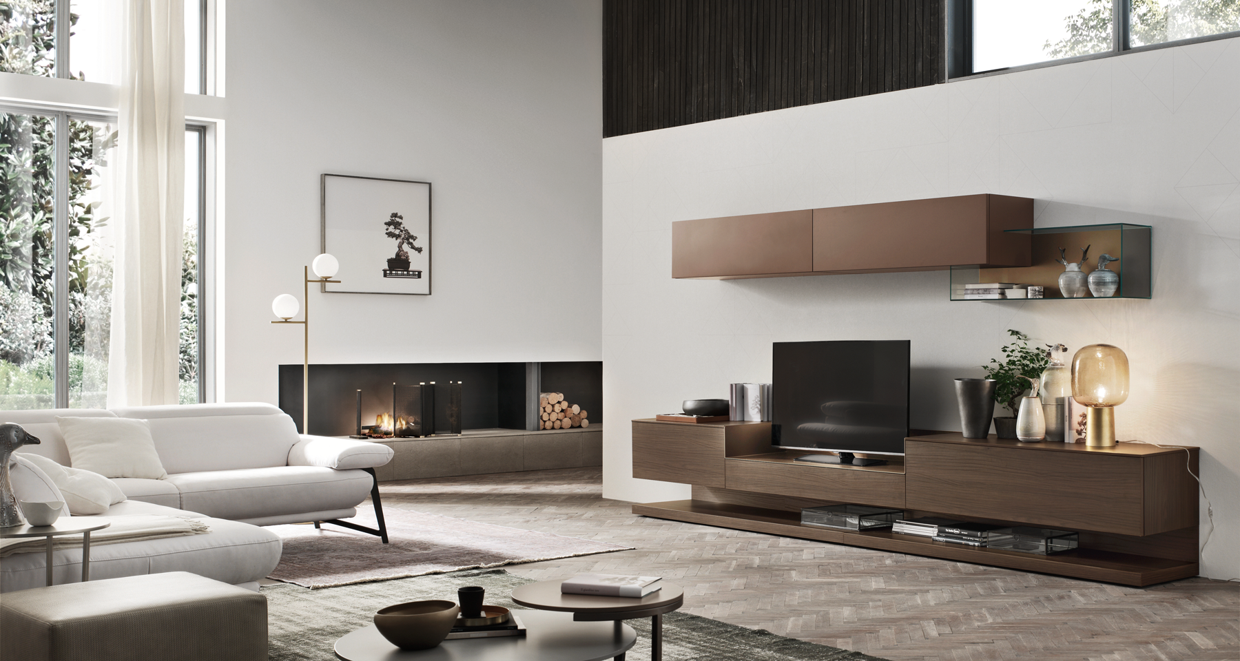 Modern living room with large windows, white sofas, a fireplace, a wooden TV stand, and decorative vases and lamps.