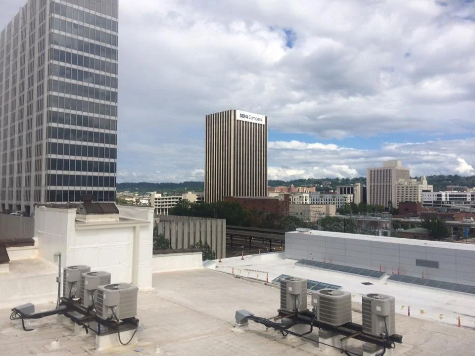 View of a city skyline with several tall buildings, including one with the