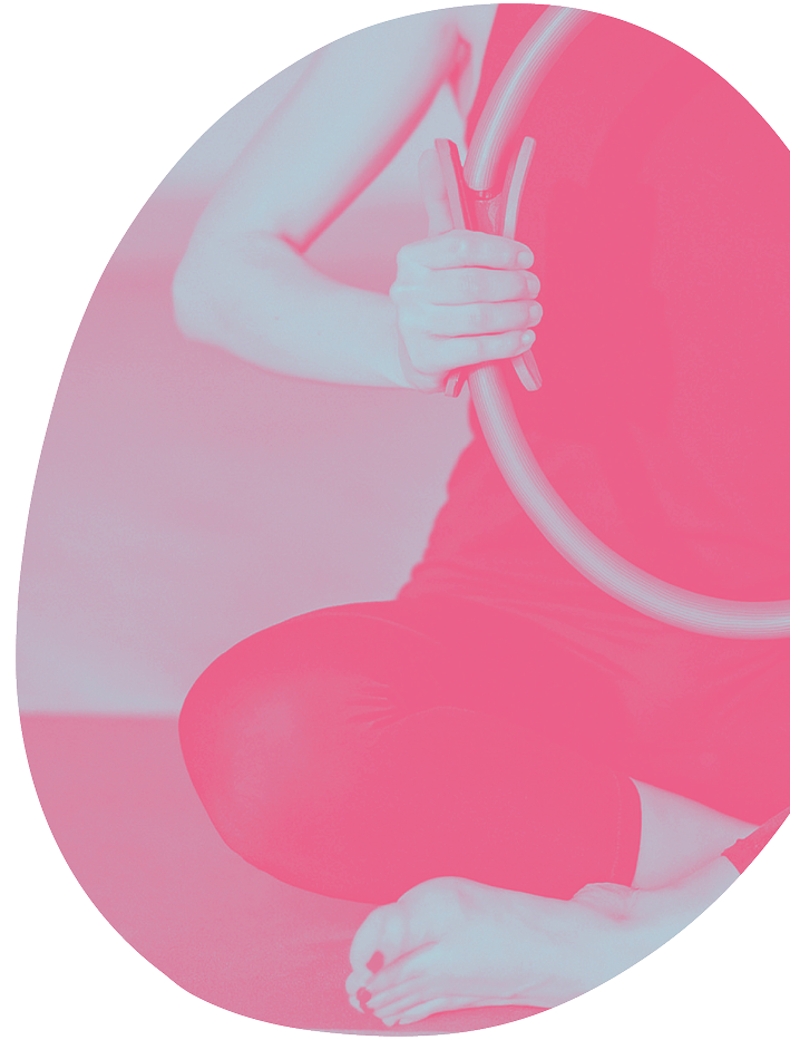 Close up of a person using a pilates magic circle ring for resistance training at Nourished Pilates in Hughesdale