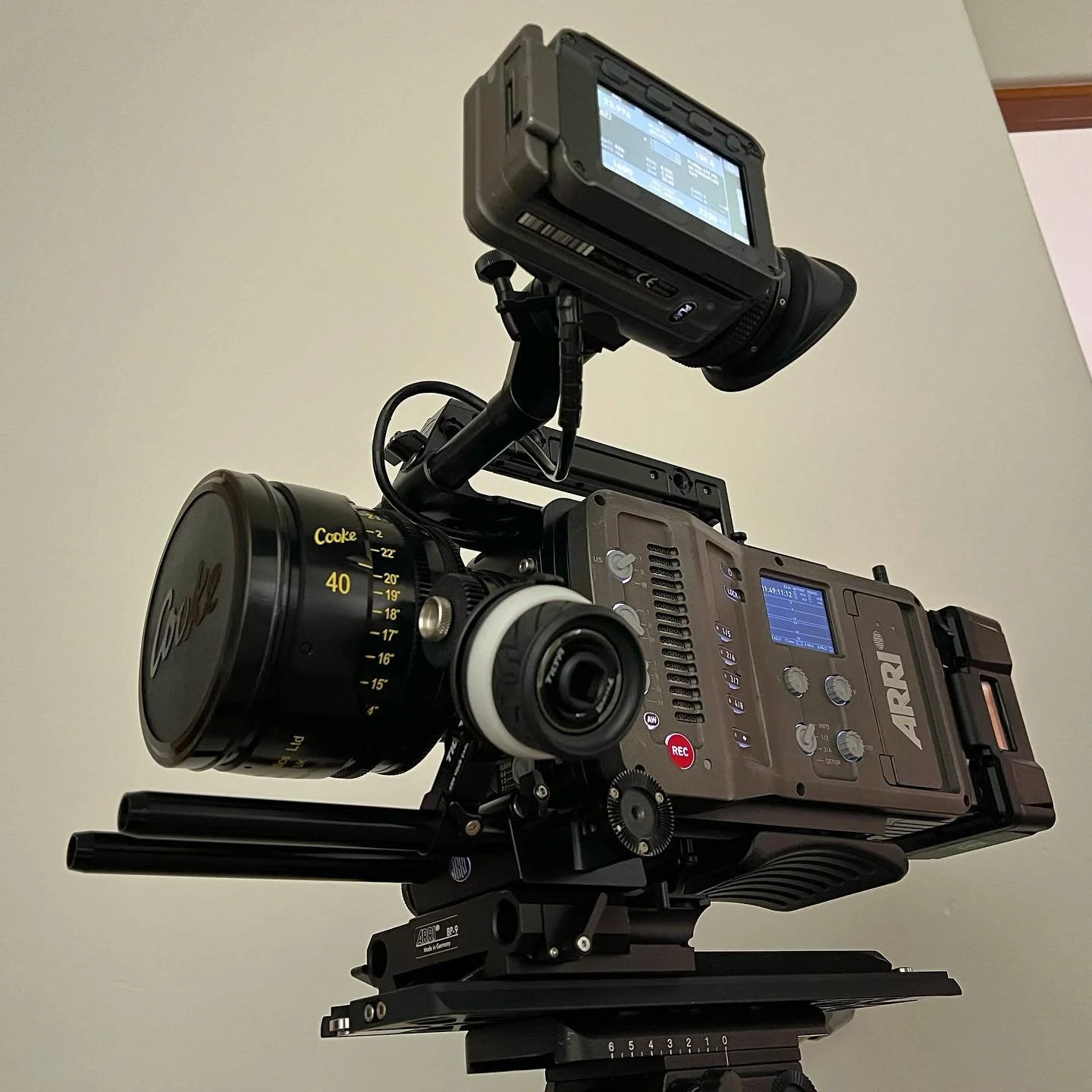 A professional ARRI camera mounted on a tripod with a matte box, accompanied by a Cooke Panchro lens and a monitor, against a plain background. Corgan Studio film equipment. 