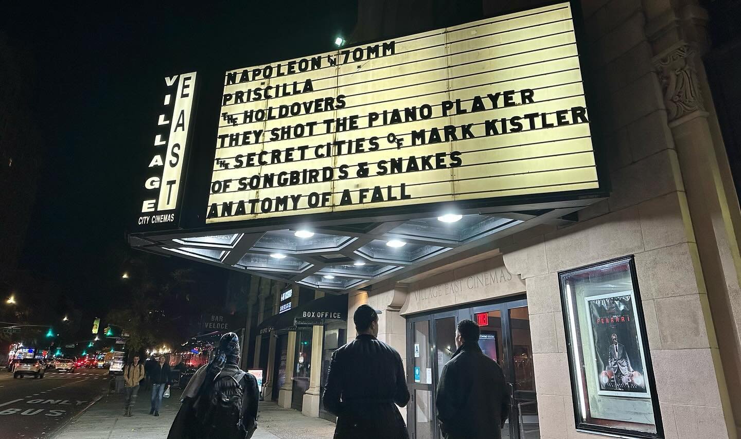 Nighttime scene outside the East Village Cinemas in New York City with a large illuminated marquee sign listing a film by Corgan Studio, directed by Jason Corgan Brown. 