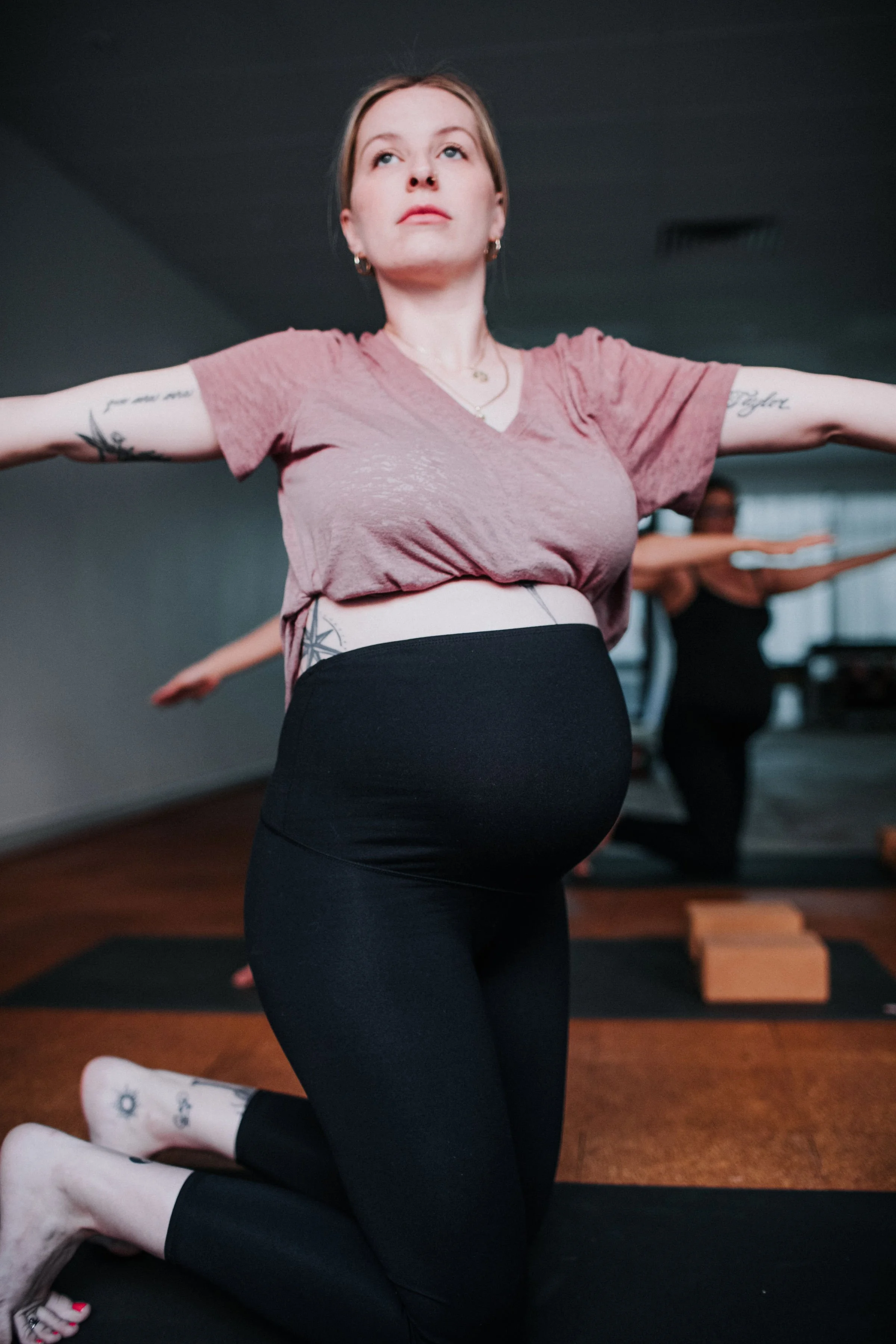 A pregnant woman practicing pregnancy yoga in Bloom Yoga Room, a studio in Perth's northern suburbs.