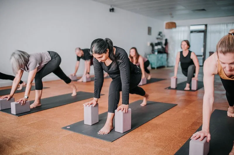 small group yoga class using blocks in a women's yoga class kingsley