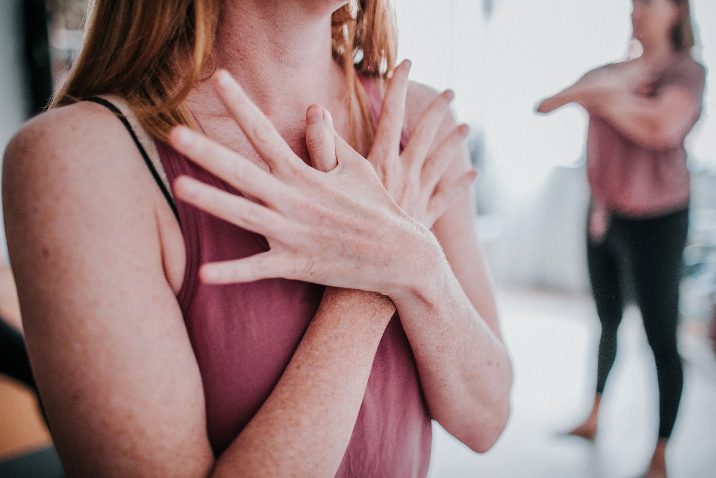 woman practicing a yoga mudra within a women's yoga class at bloom yoga in Kingsley