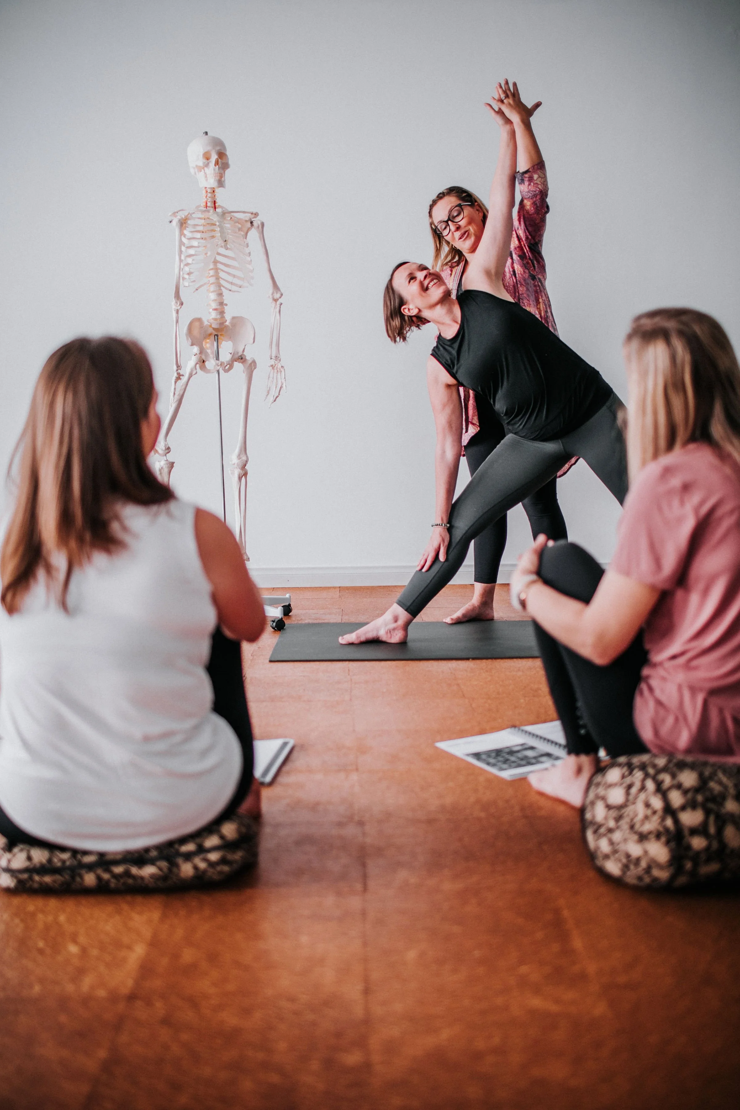 senior yoga teacher instructing an anatomy module as part of a women's 200 hour teacher training in perth at bloom yoga