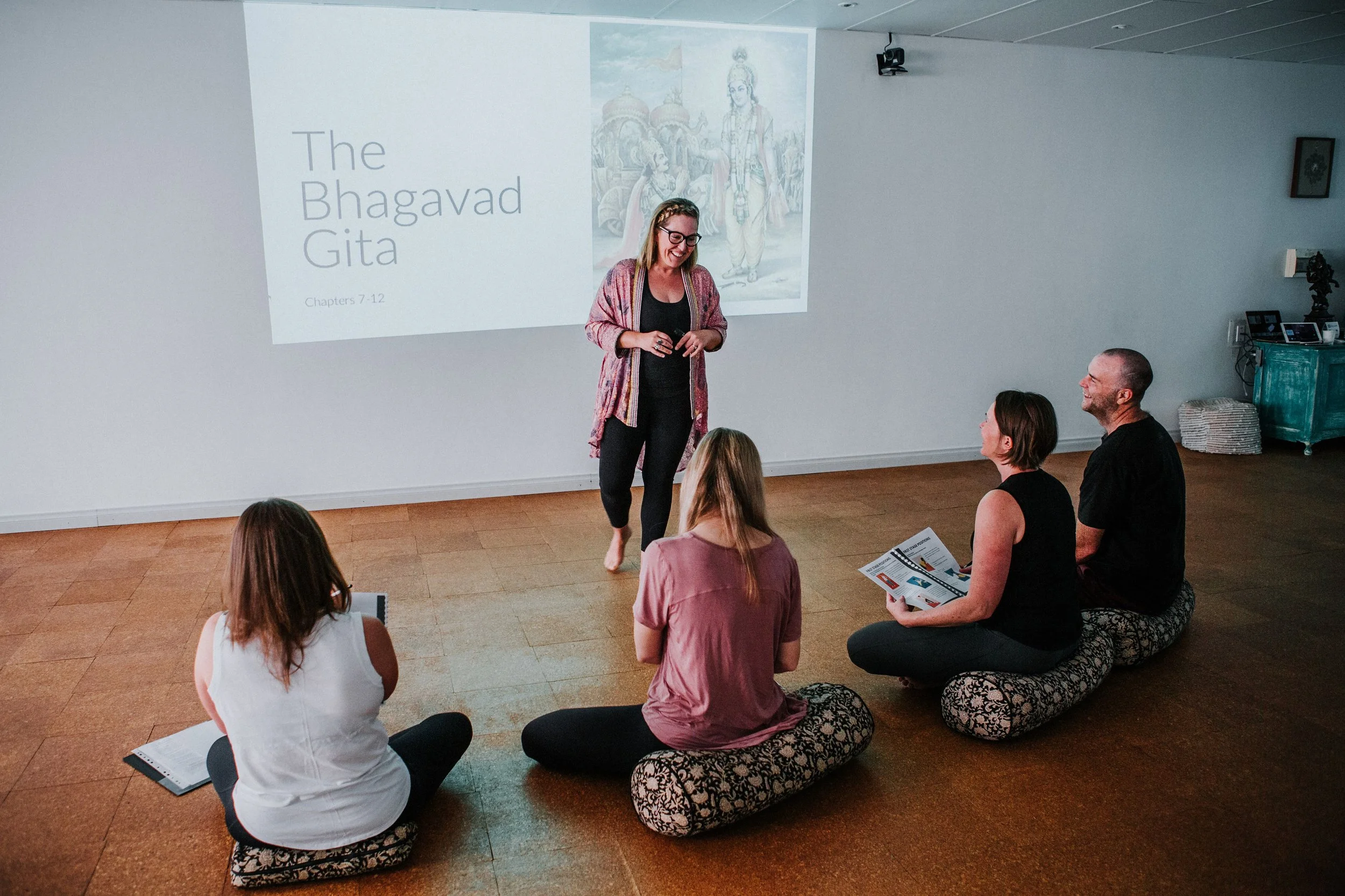 Senior Yoga Teacher taking trainees through a philosophy lecture at Bloom Yoga