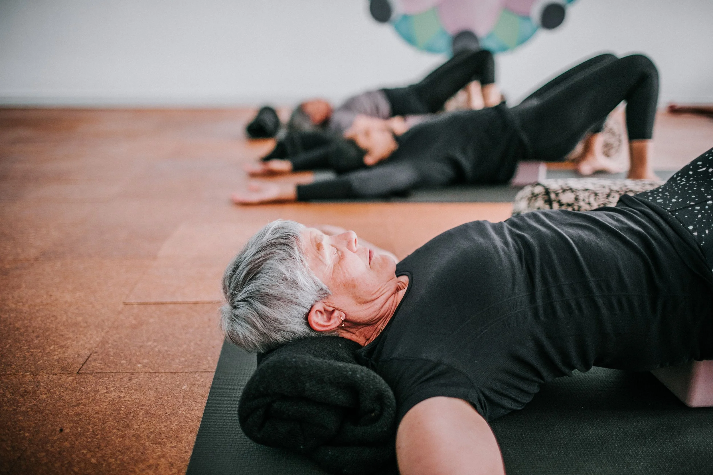Students practicing restorative yoga during teacher training in Perth