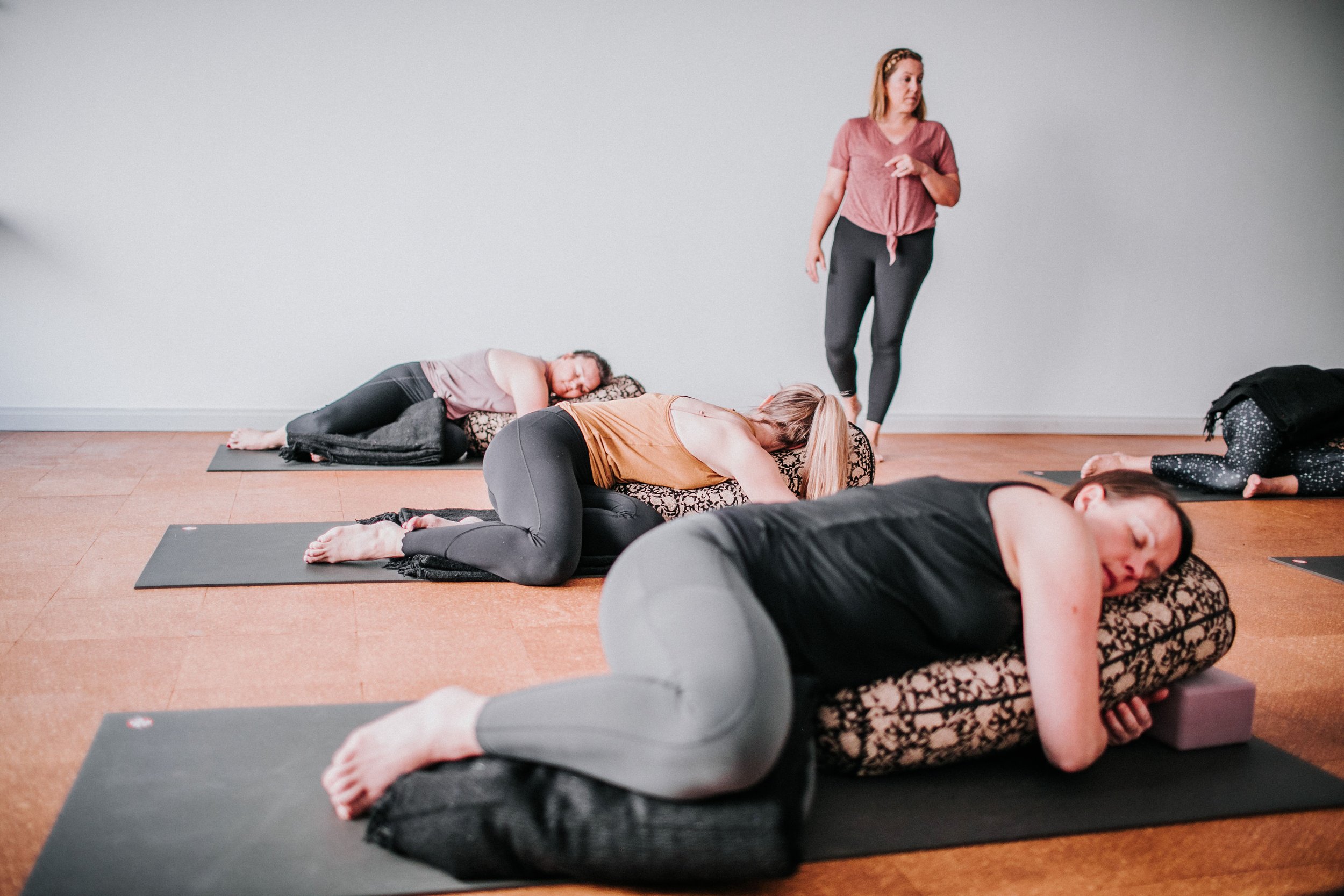 senior perth yoga teacher guiding a restorative yoga teacher training course