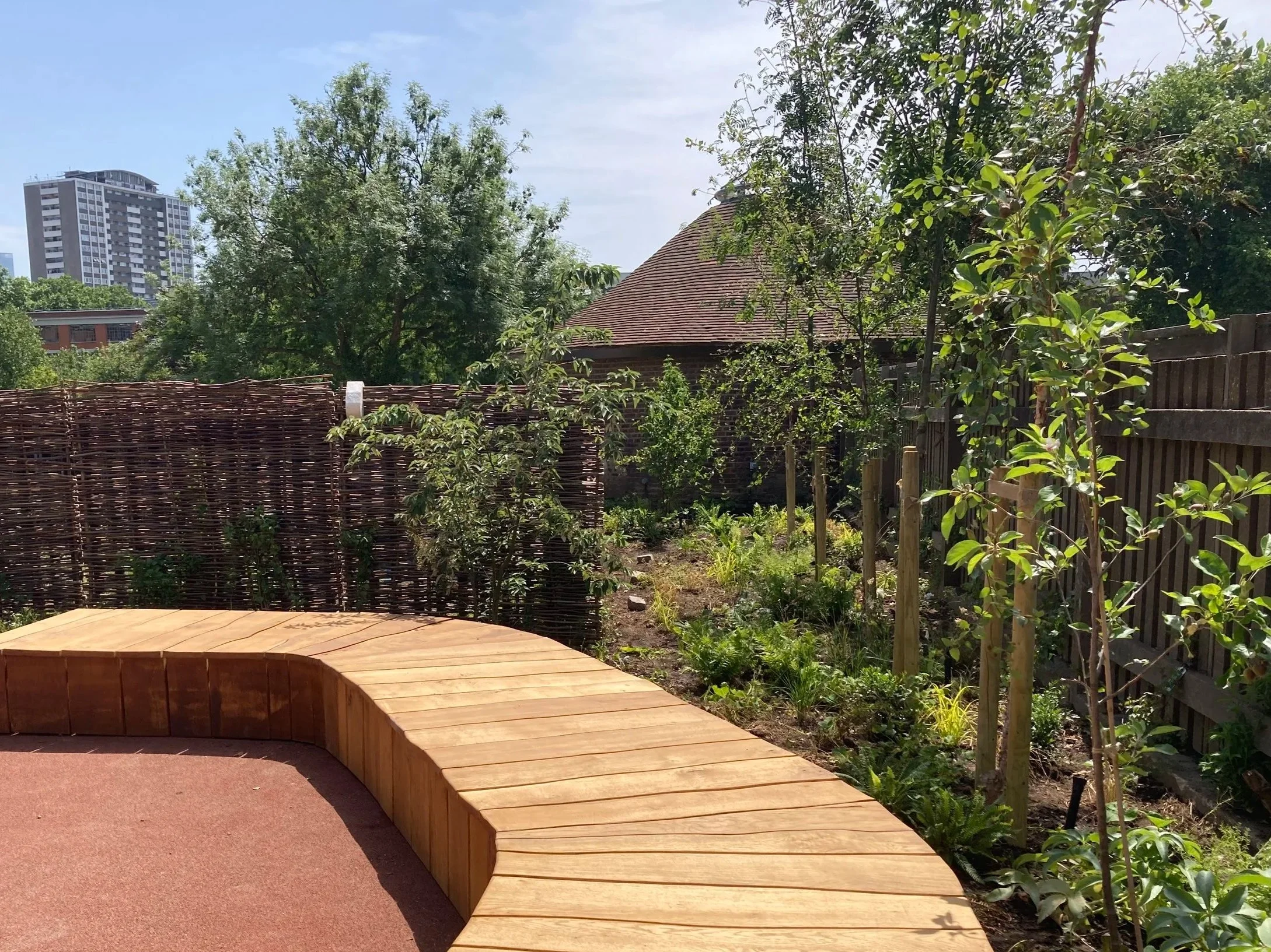 Quentin Blake Centre for Illustration. 
Areas of de paving have created new opportunities for planting at the peripheries of the site. Image shows learning area garden and deck.