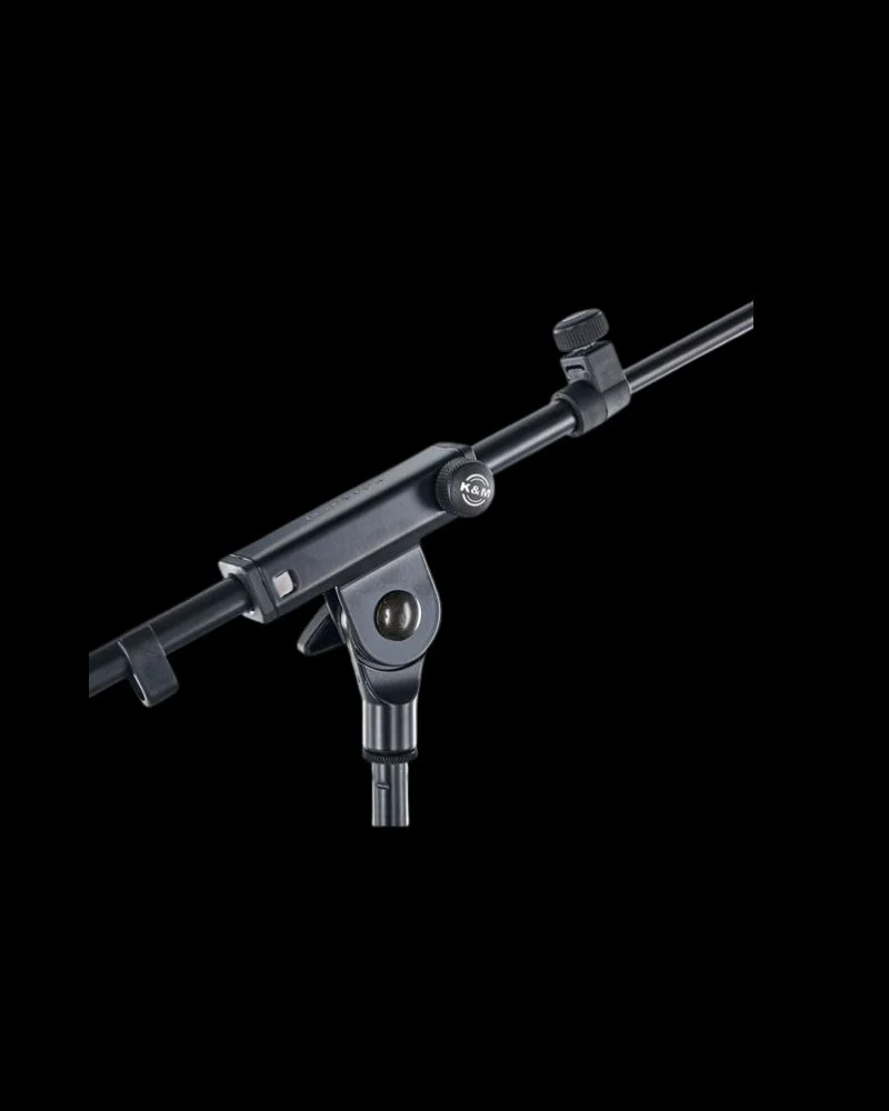 Angled view of Konig & Meyer 26020 round-base boom microphone stand for stage and events