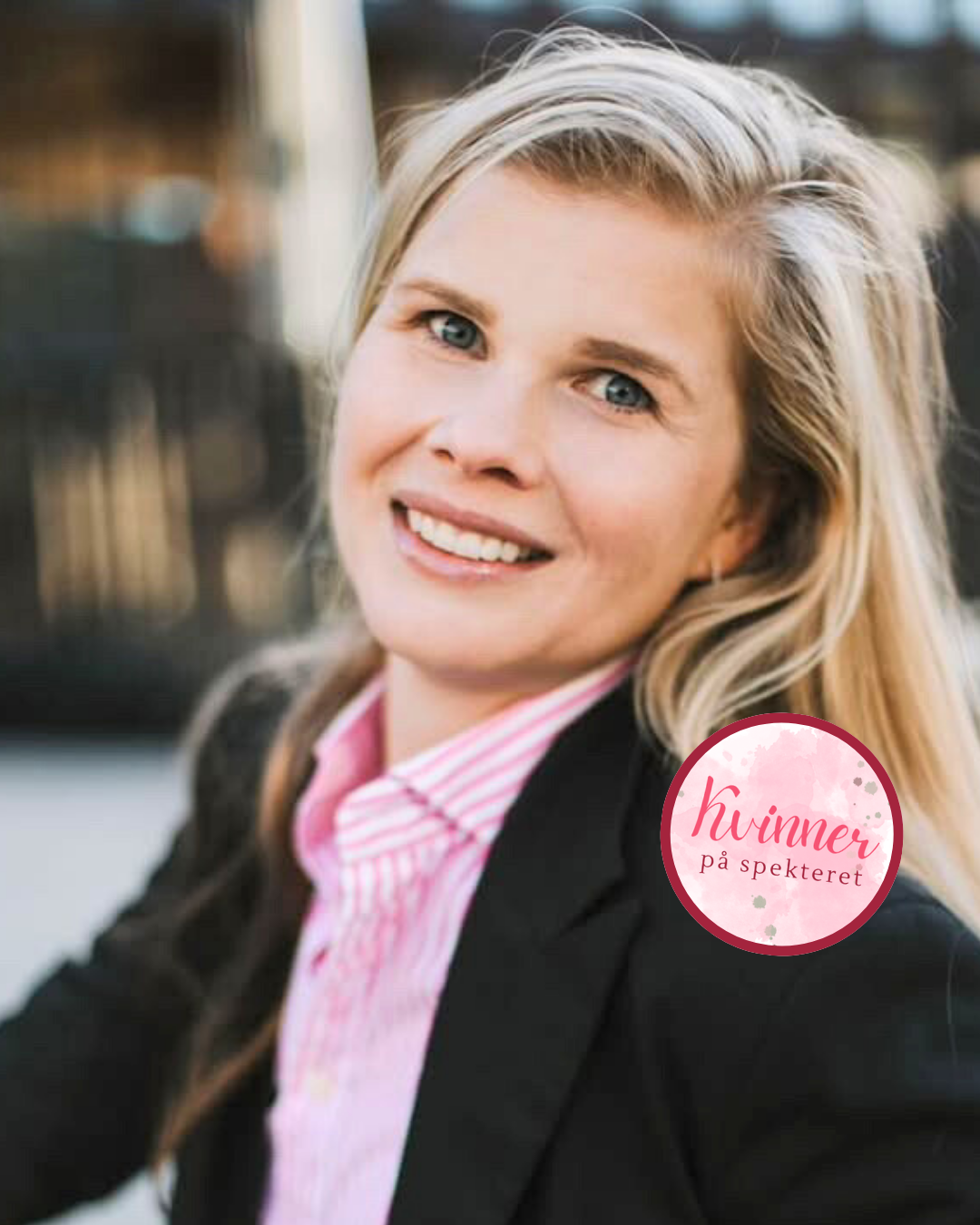 En glad kvinne som sitter ute. Hun smiler og har forstått seg selv etter å ha fått diagnosen ADHD i voksen alder. Det er en rosa ring hvor det står kvinner på spekteret.