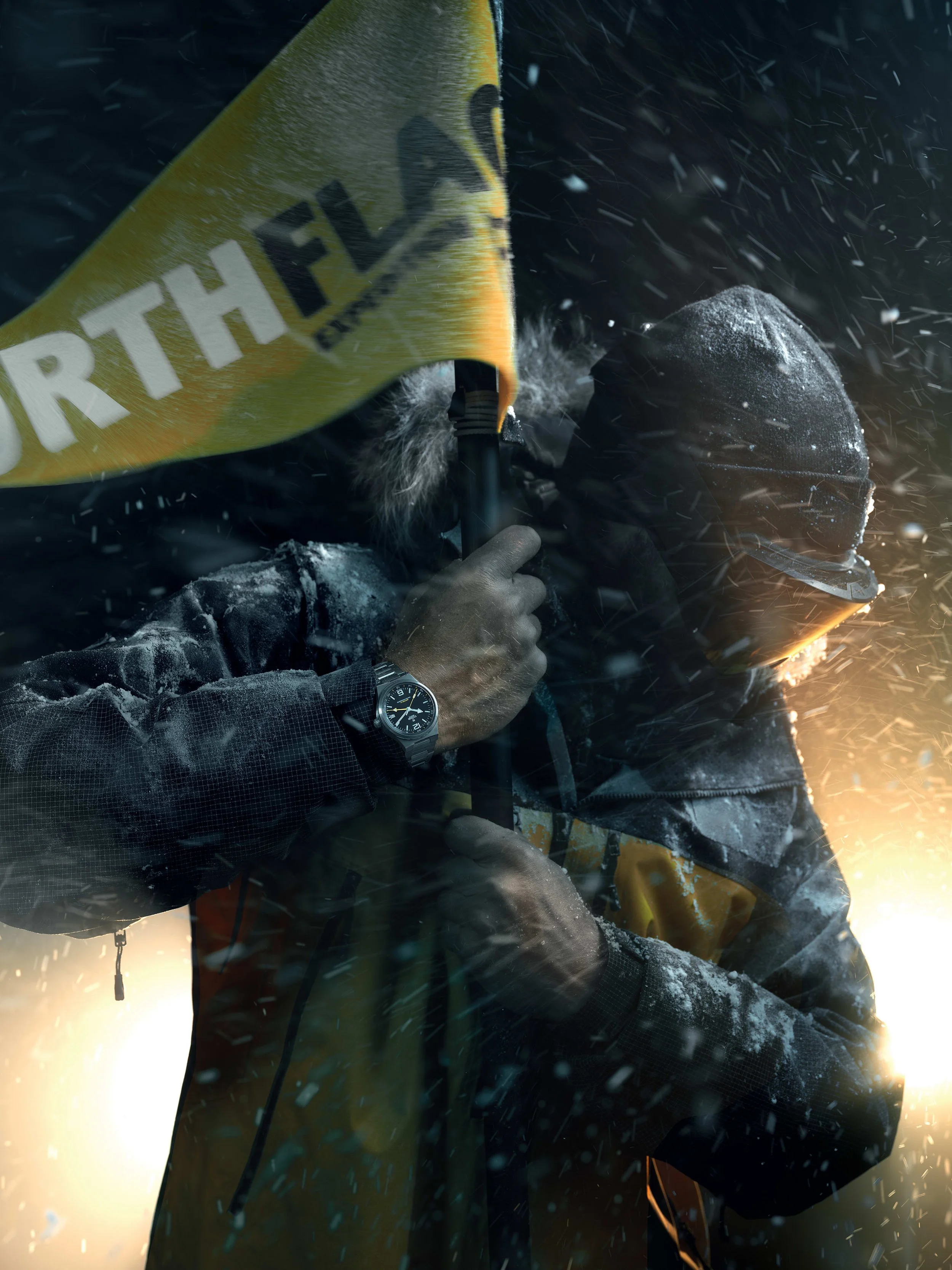 Explorer wearing the Tudor North Flag GMT while battling through extreme Arctic conditions with a North Flag expedition flag.