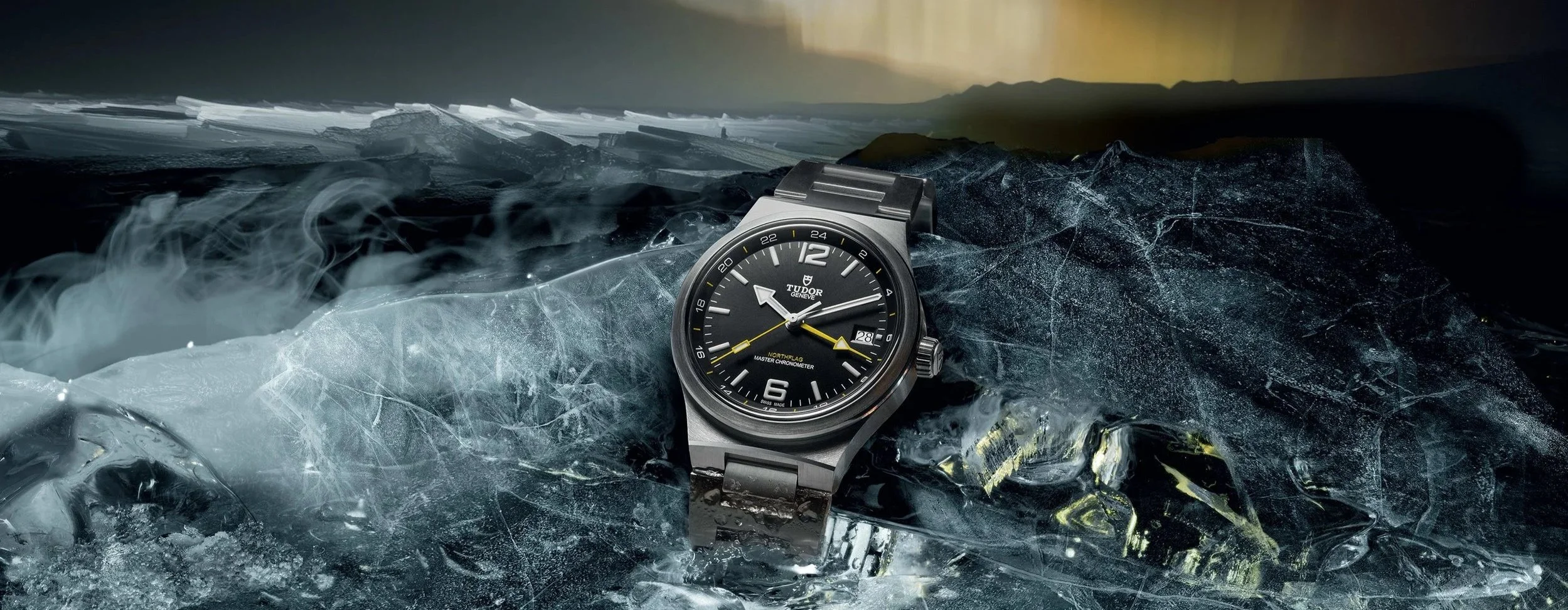 **Alt text:** Tudor North Flag GMT watch resting on cracked ice beneath the Northern Lights, reflecting its Arctic expedition heritage.