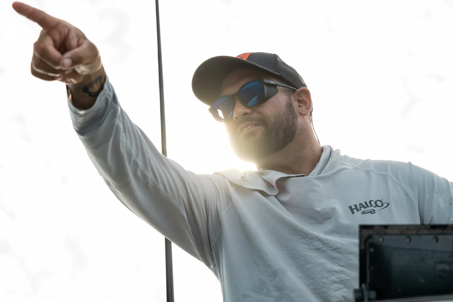 Pointing out large schools of bait topwater fishing from a Contender 25 centre console fishing for Halco