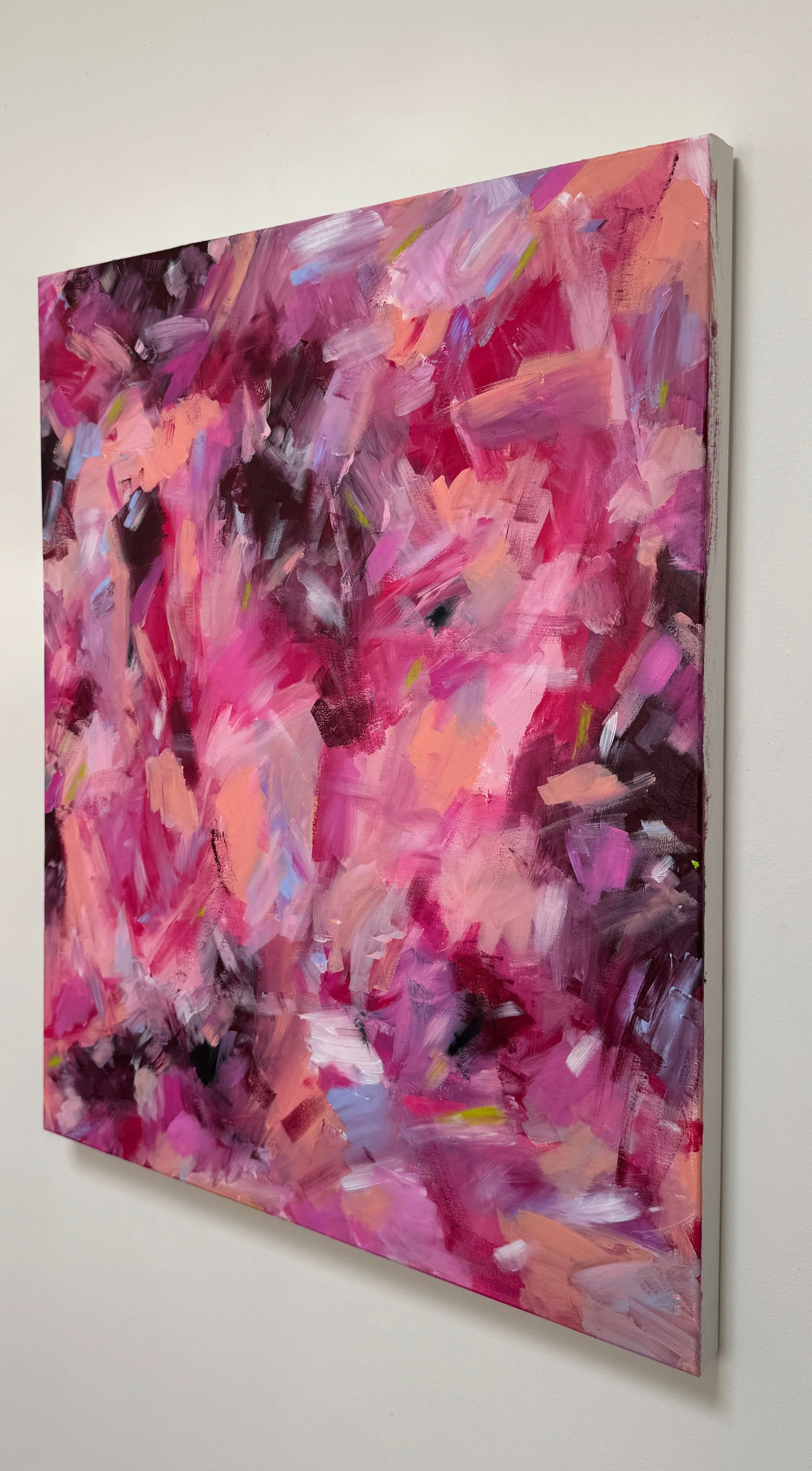 Abstract pink and purple painting on a wall wall.