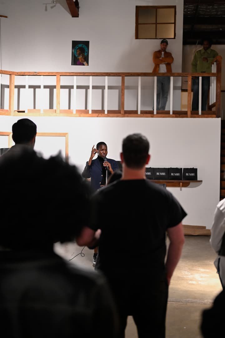 Nyaluak Leth speaks in front of the crowd at Afrikaleidoscope art exhibit