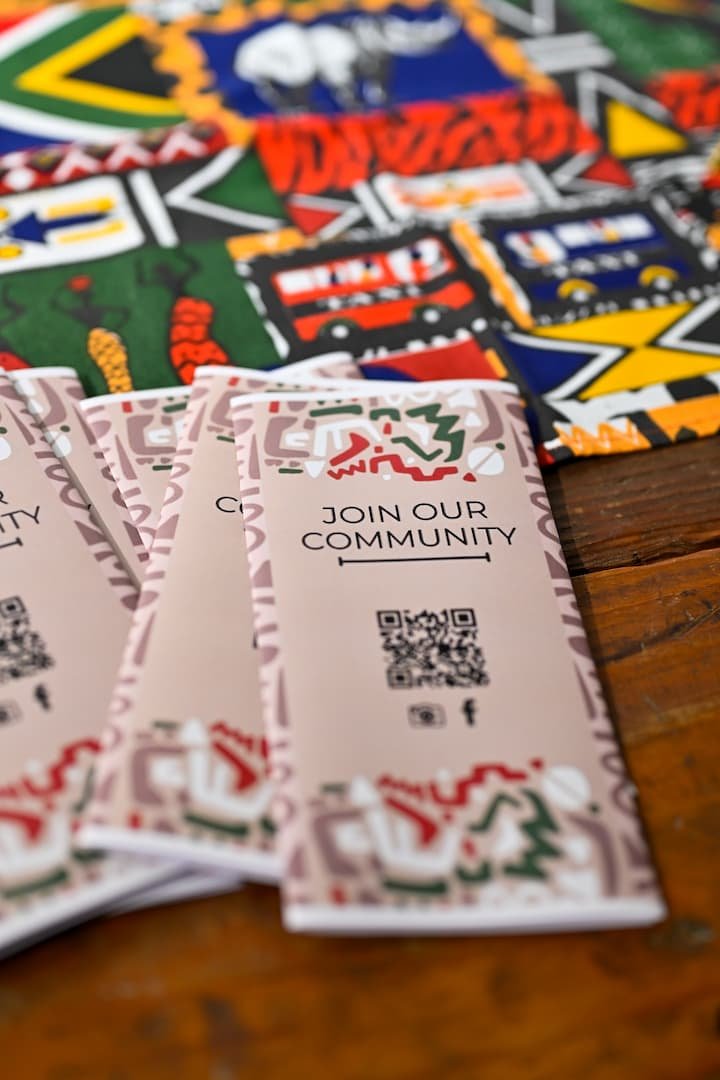 Pink brochures and colorful textile background at Afrikaleidoscope