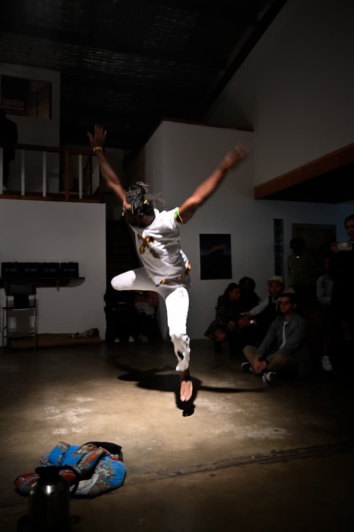 Lucky Lartey mid-dance performance at AfriKaleidoscope exhibit