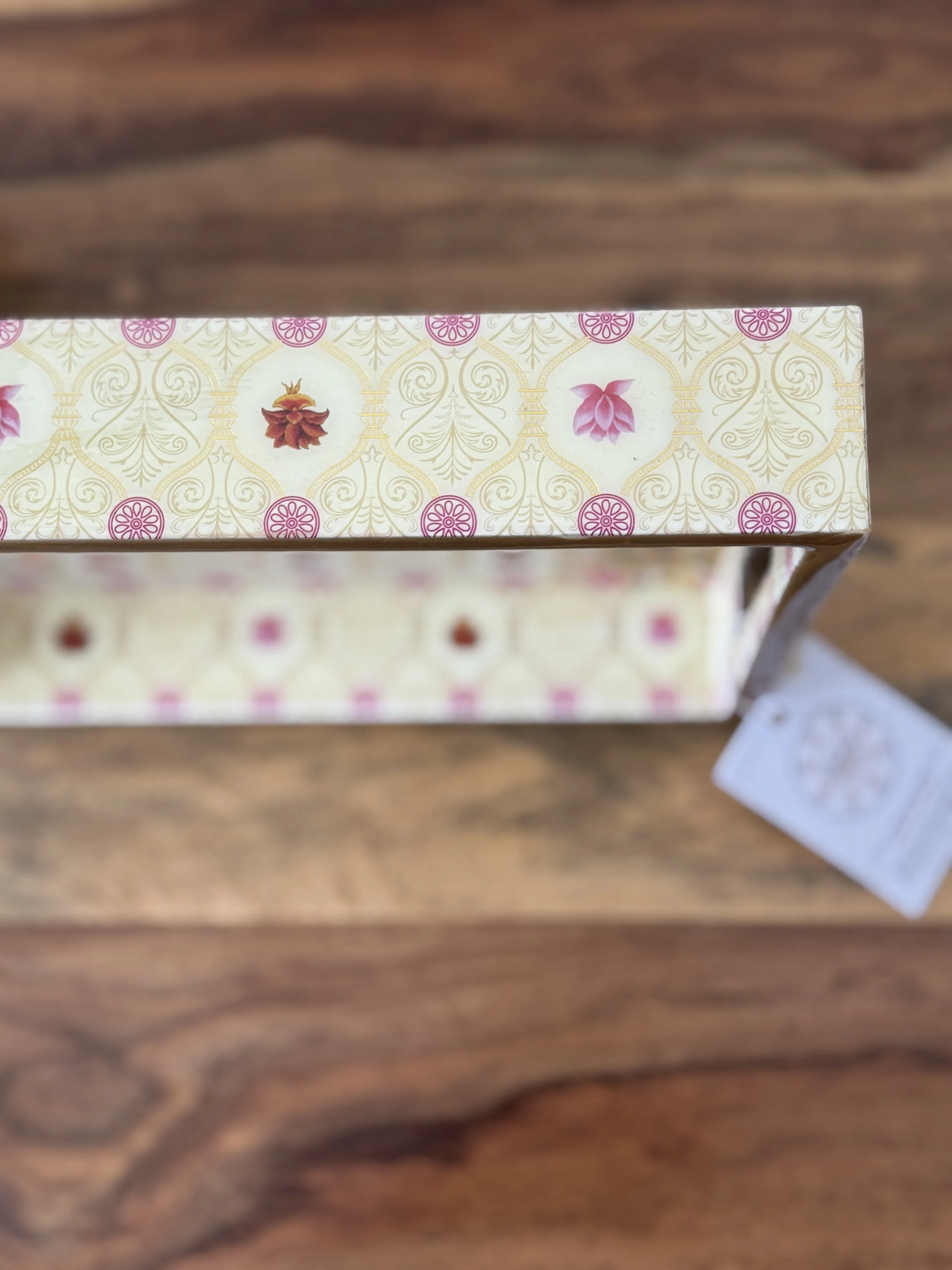 Ivory and pink floral pattern on the larger edge side of the tray